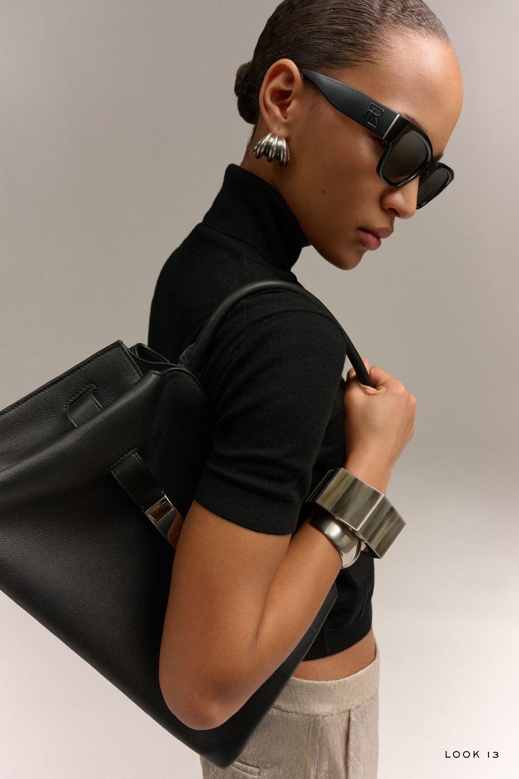 black fitted top with beige pants