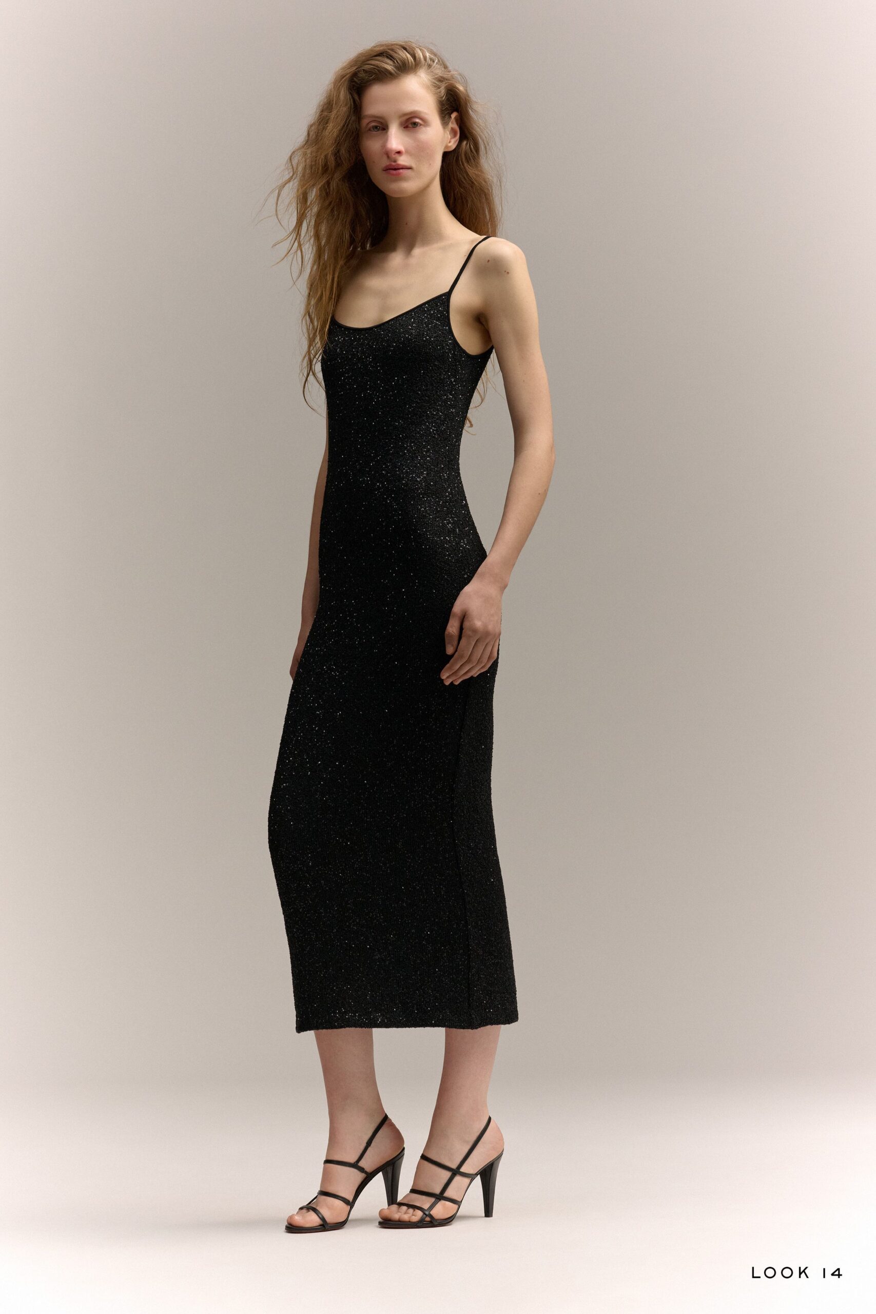 black fitted midi dress with strappy heels