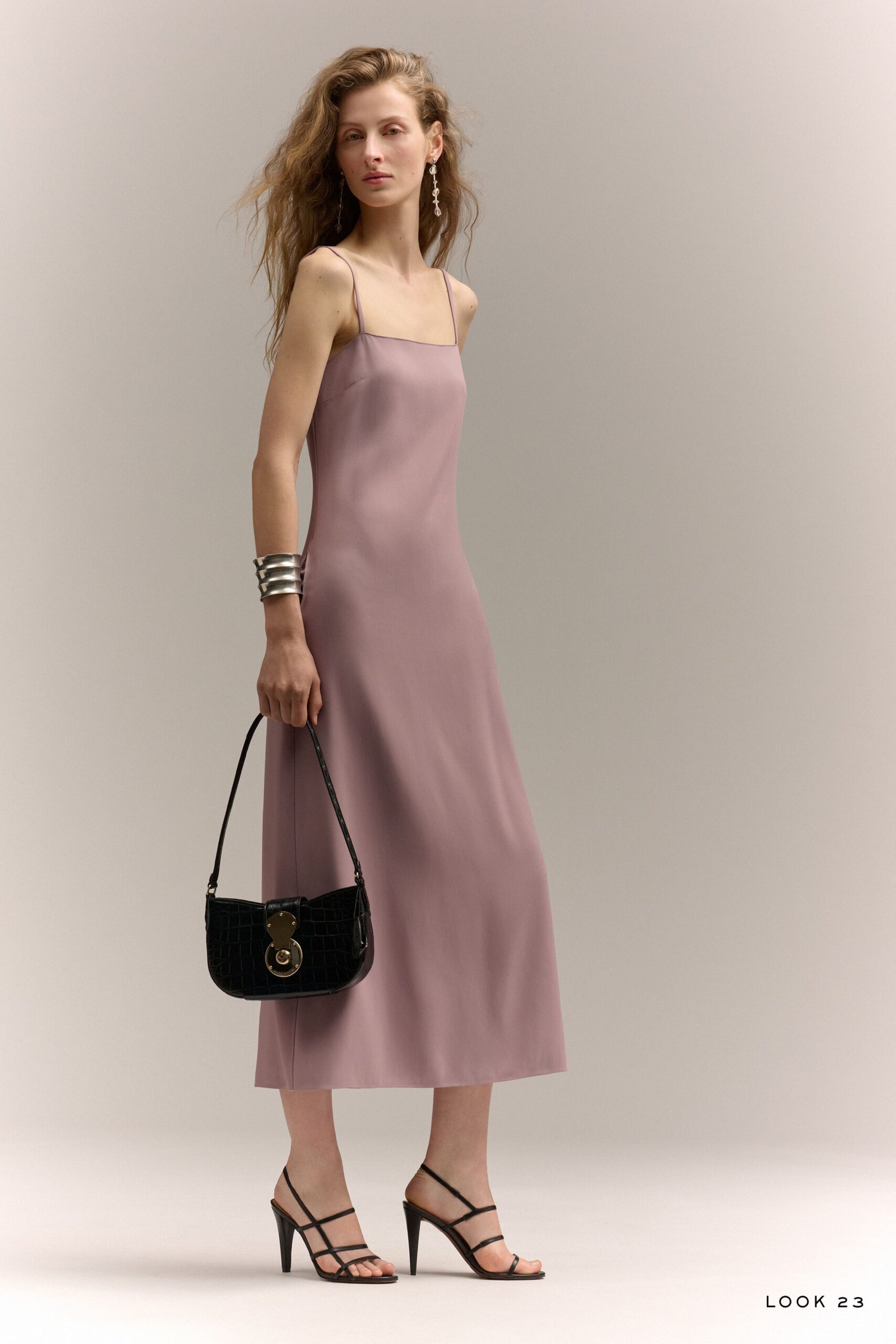 pink silk midi dress with black accessories