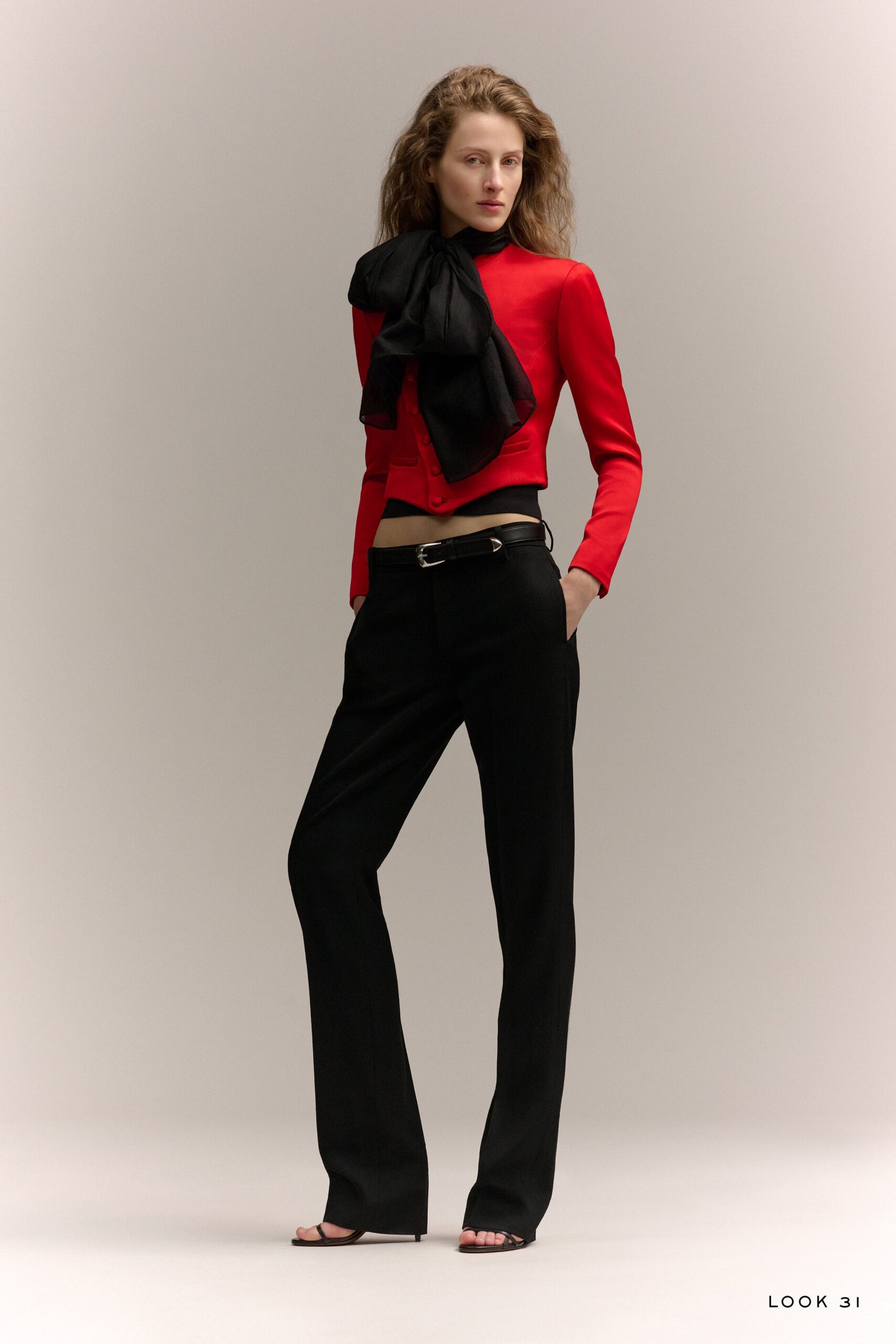 red fitted top with black pants