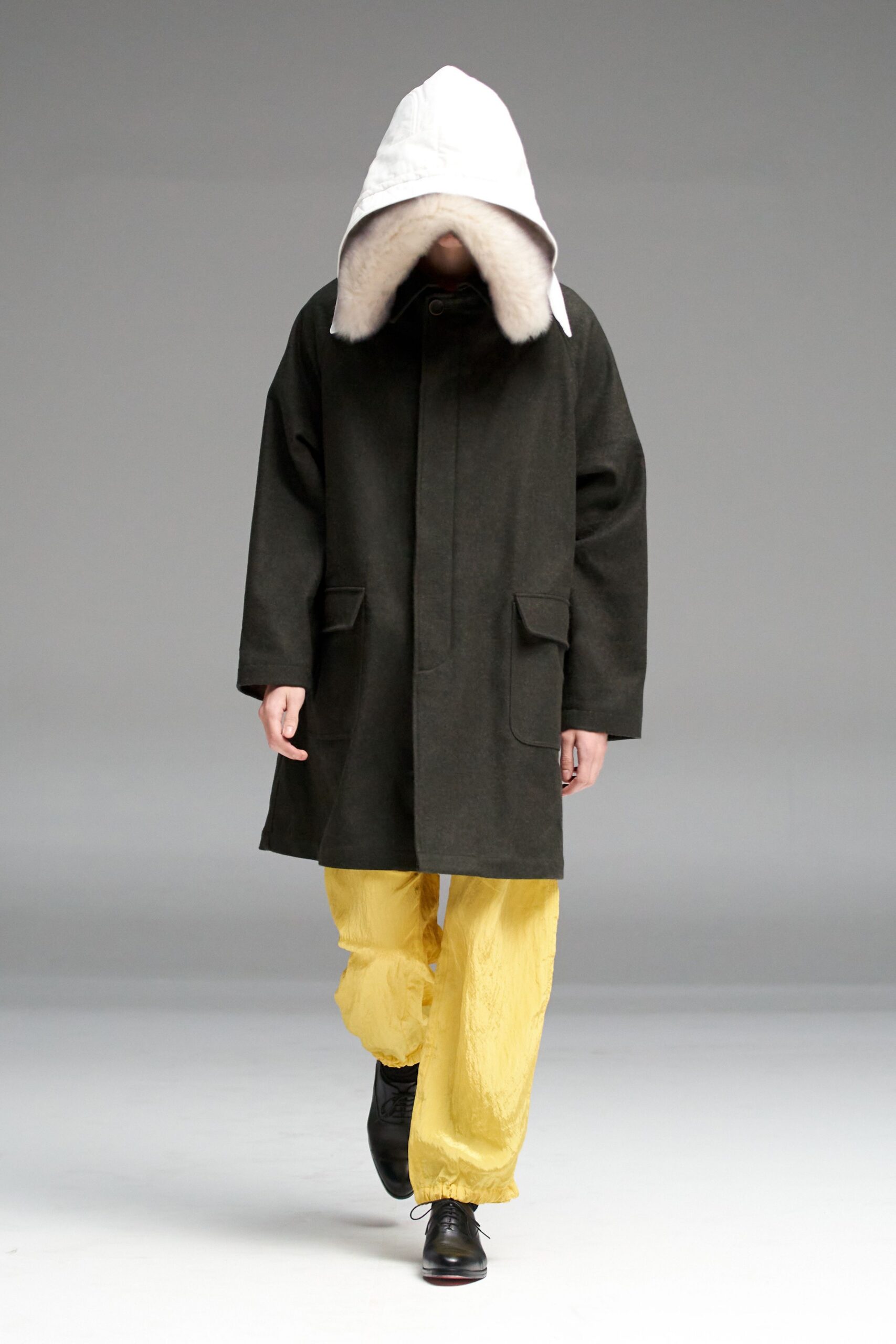 black wool coat yellow pants