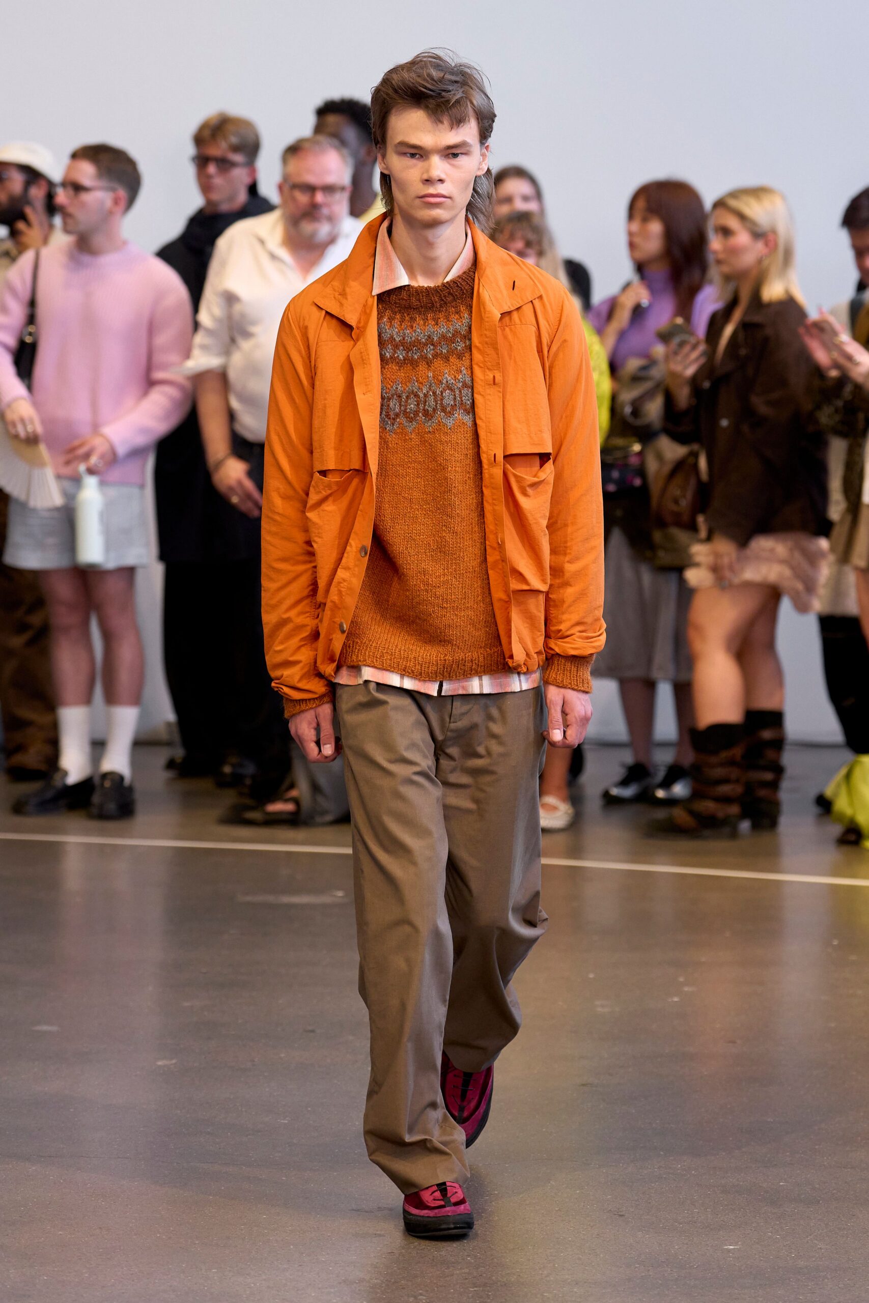 orange jacket and beige pants