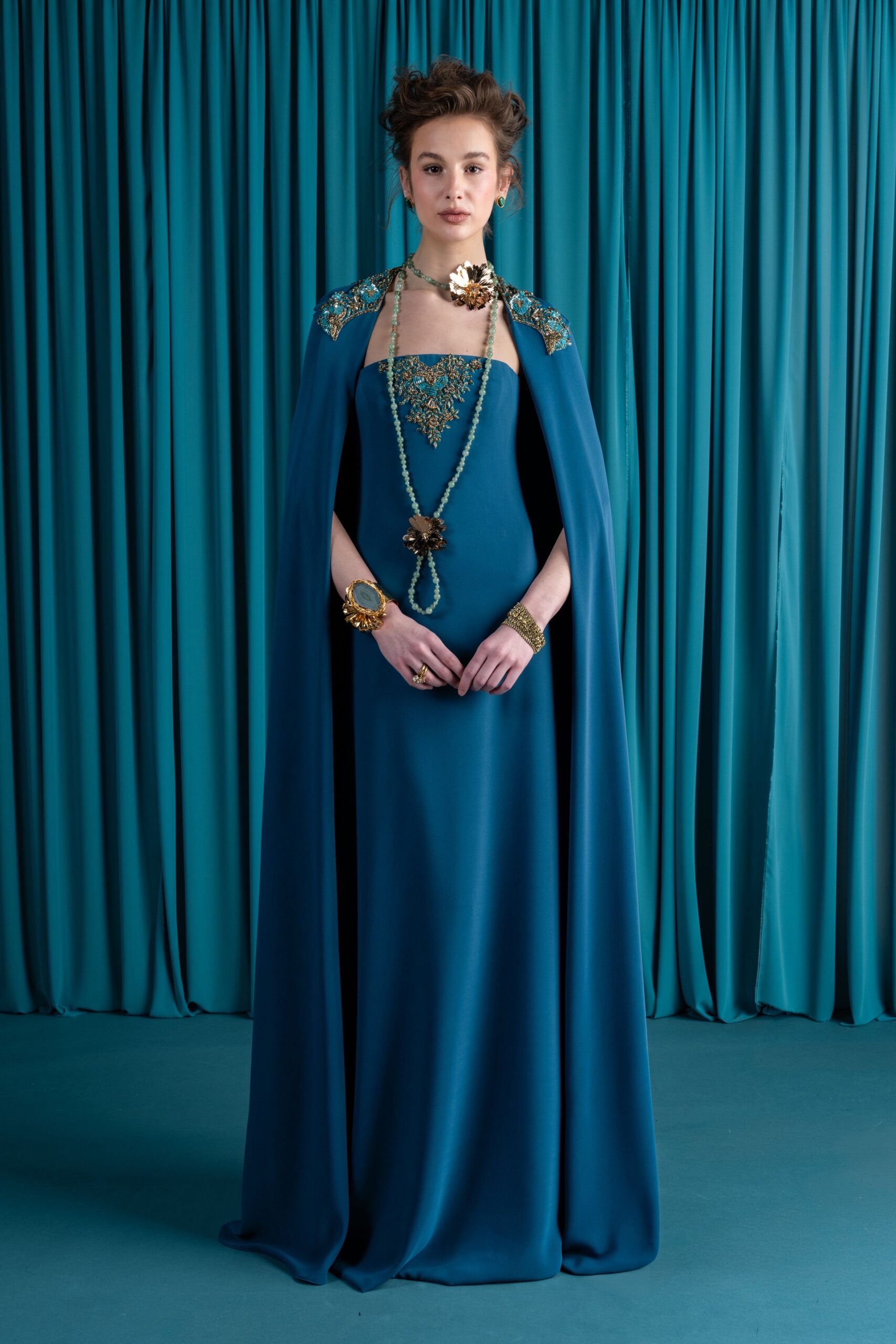 blue embellished gown with cape