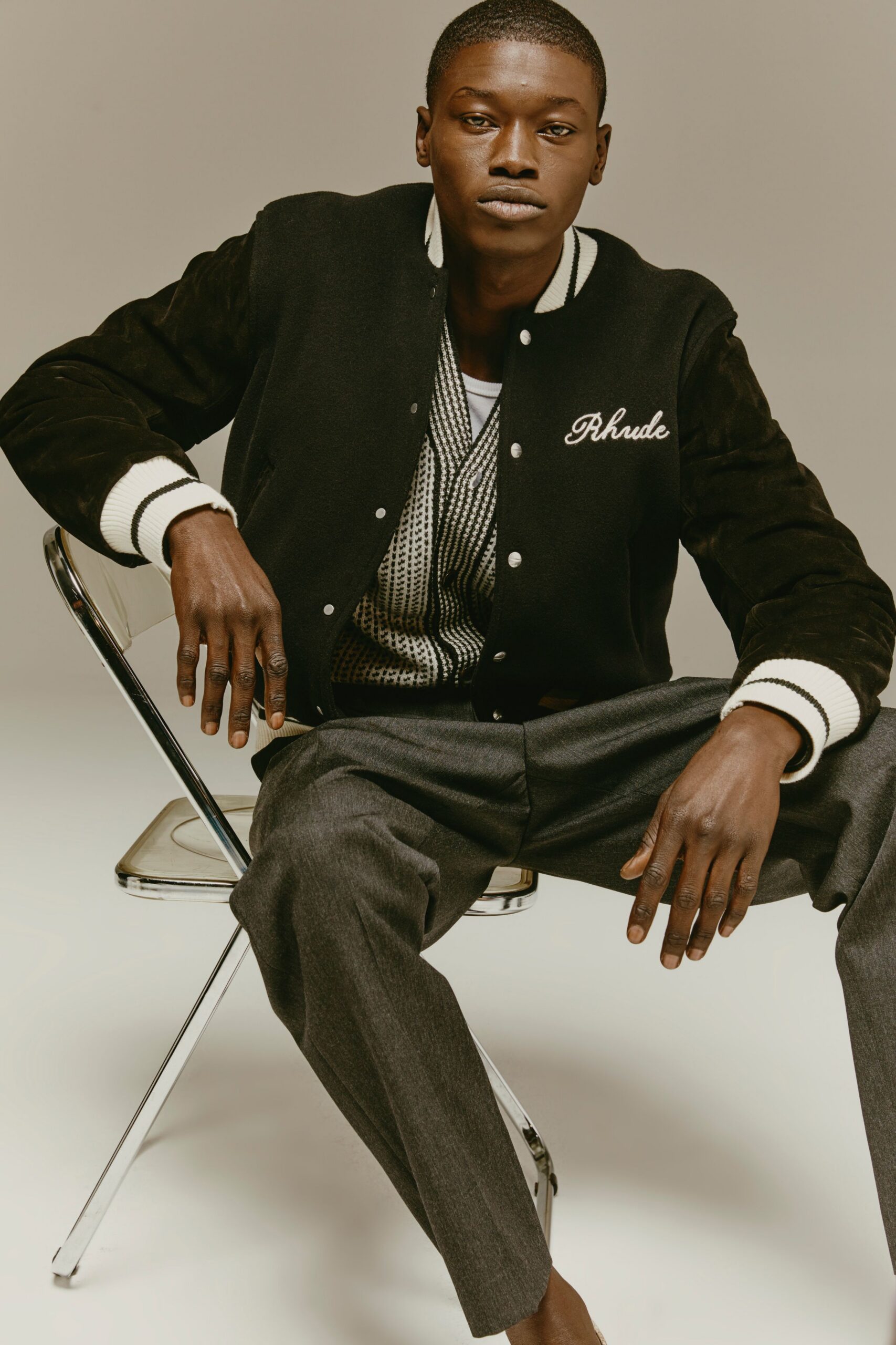 black jacket gray sweater tailored pants