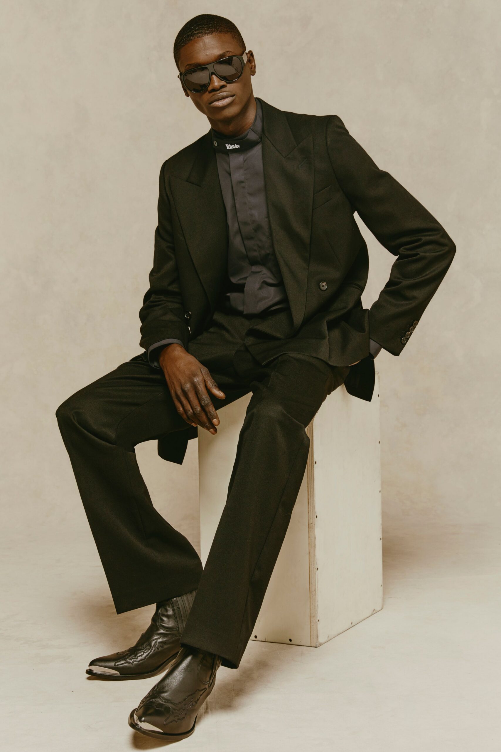 black tailored suit with sunglasses