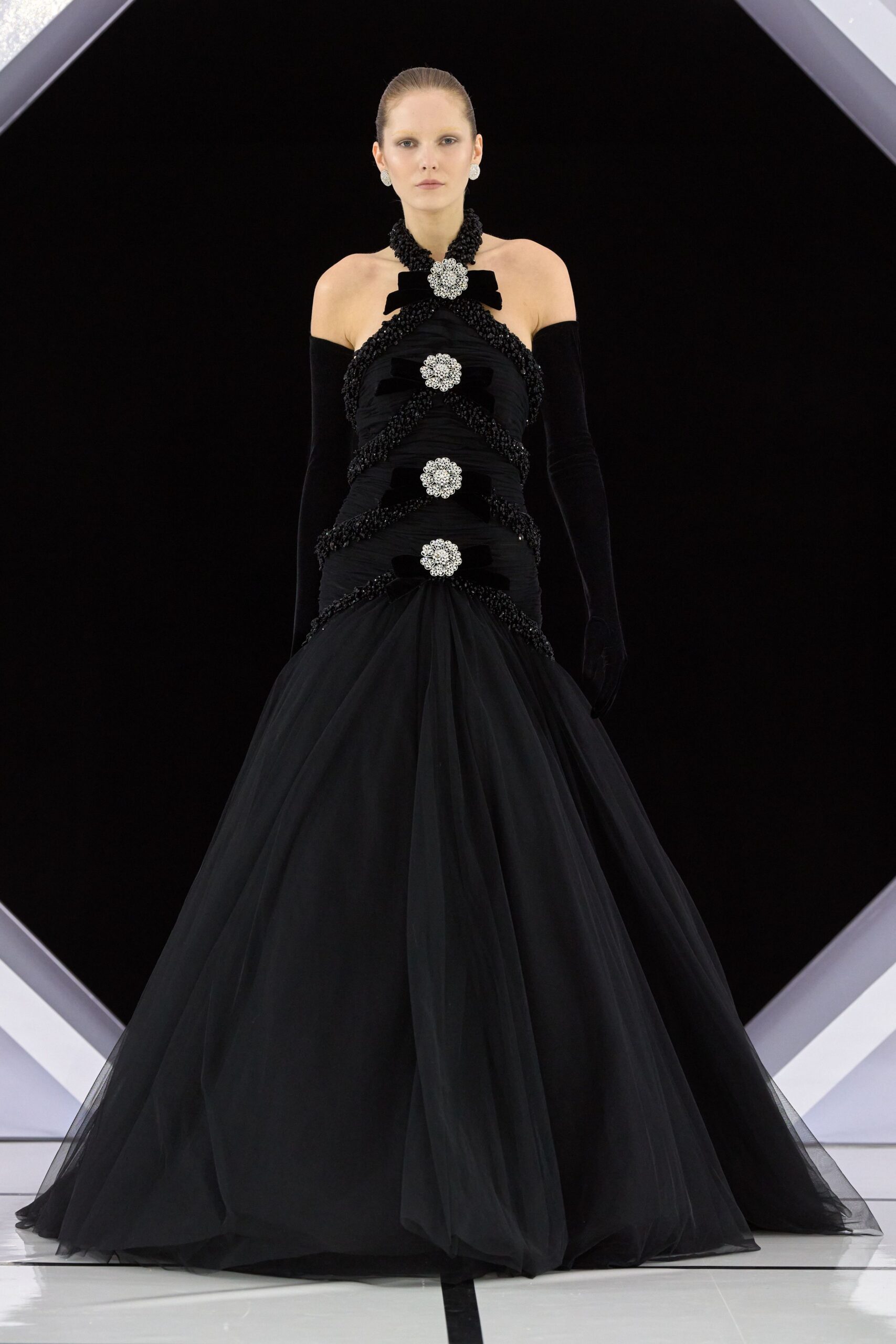 black tulle strapless fitted layered pleated flowing gown