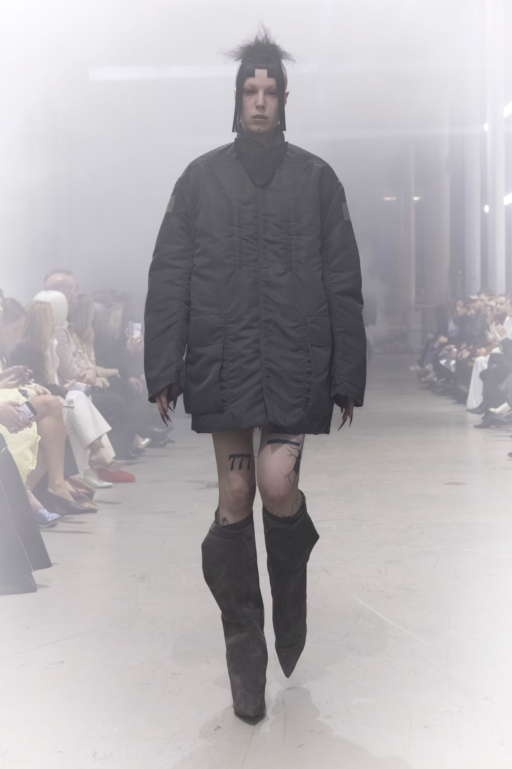 black oversized quilted coat with brown boots