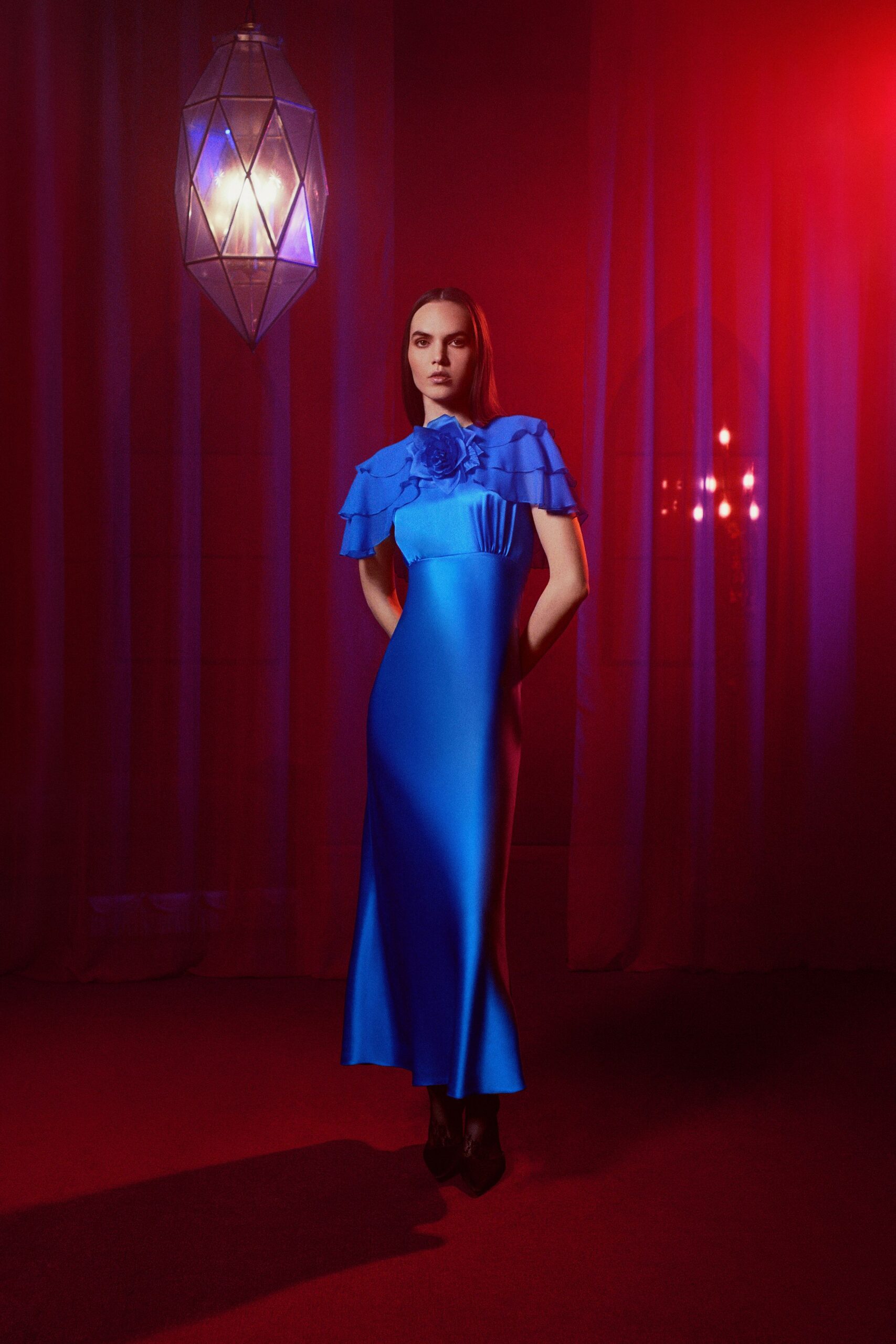 blue silk sleeveless high-neck fitted ruffled pockets gown