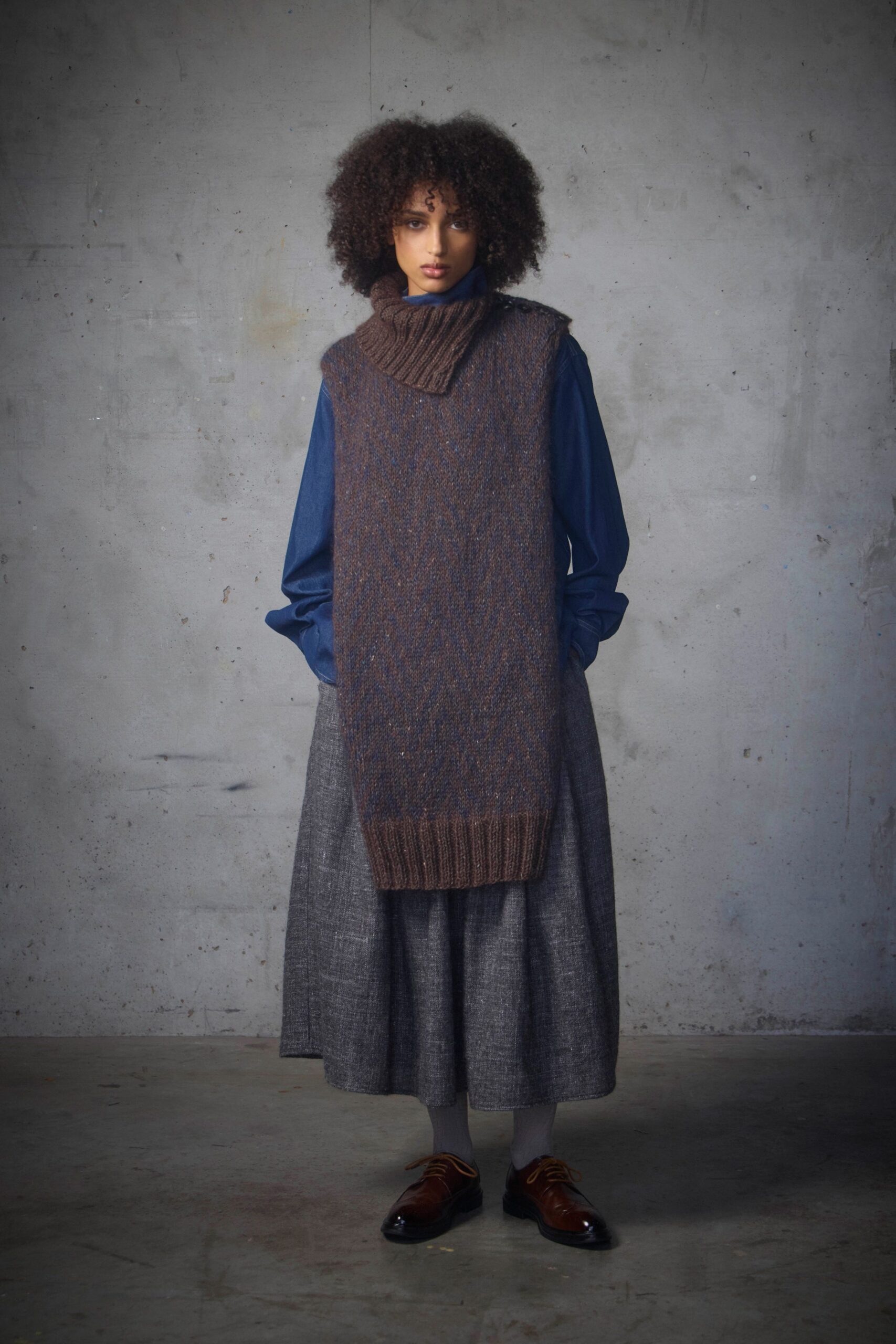 brown wool sleeveless sweater with blue shirt