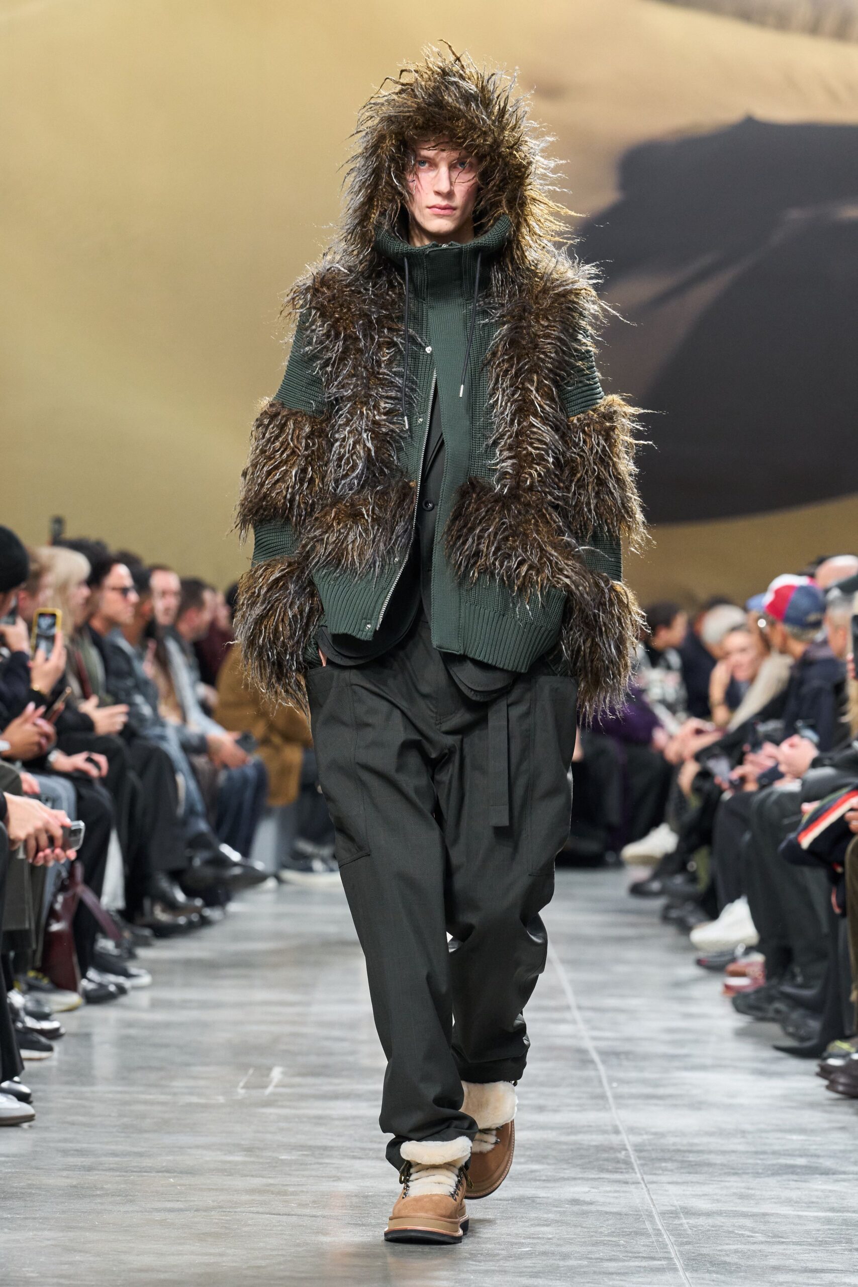 green fringed jacket with black pants