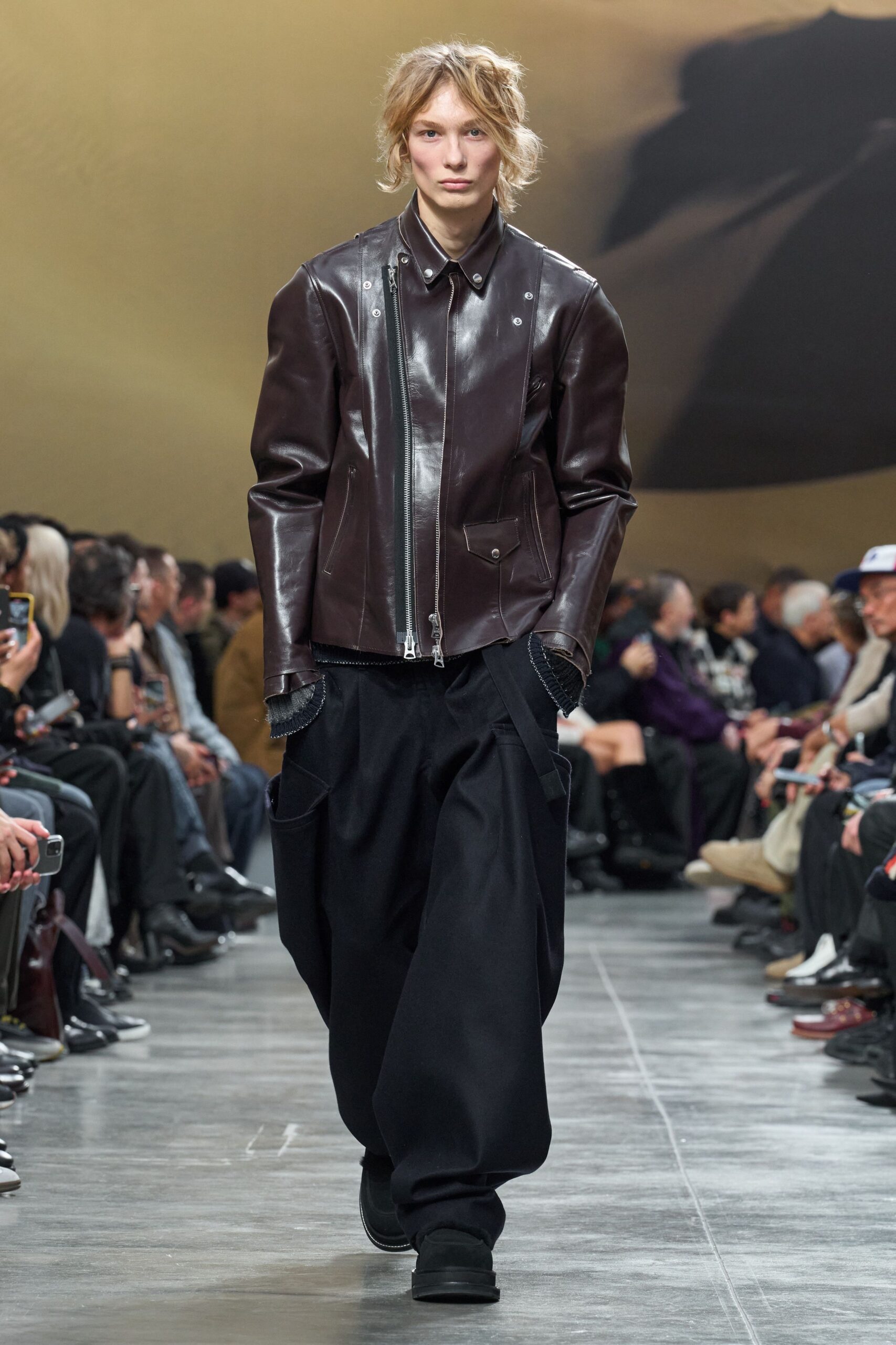 brown leather jacket with black pants
