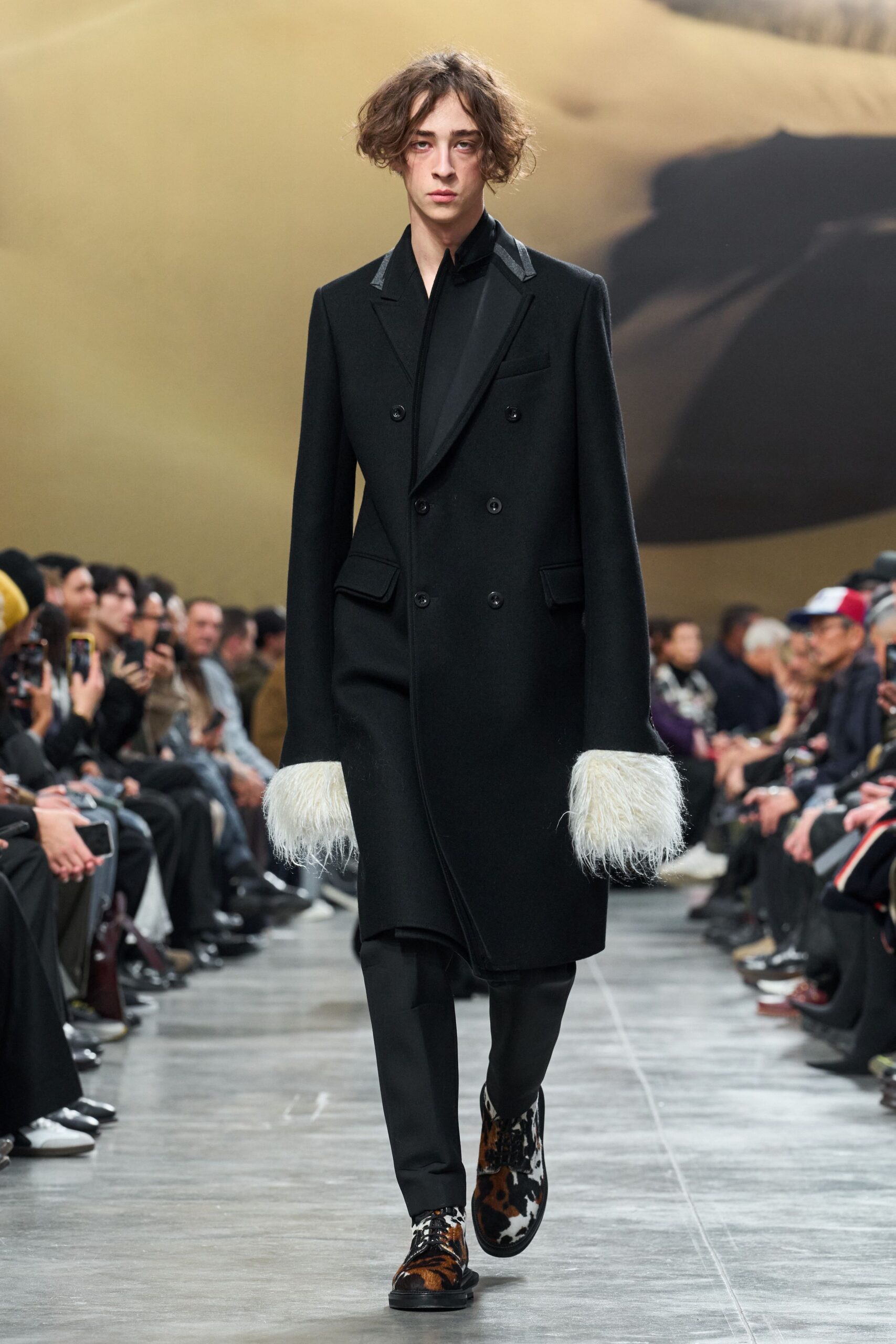 black tailored coat with fringed sleeves