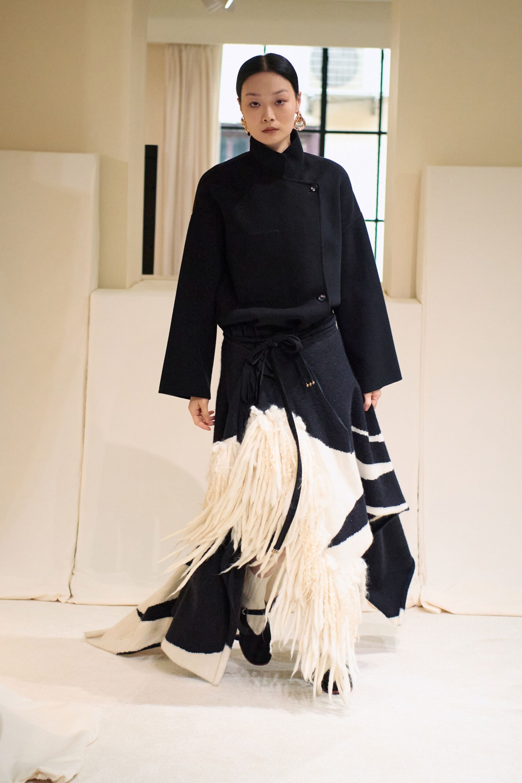 black wool long-sleeve collared structured buttoned coat