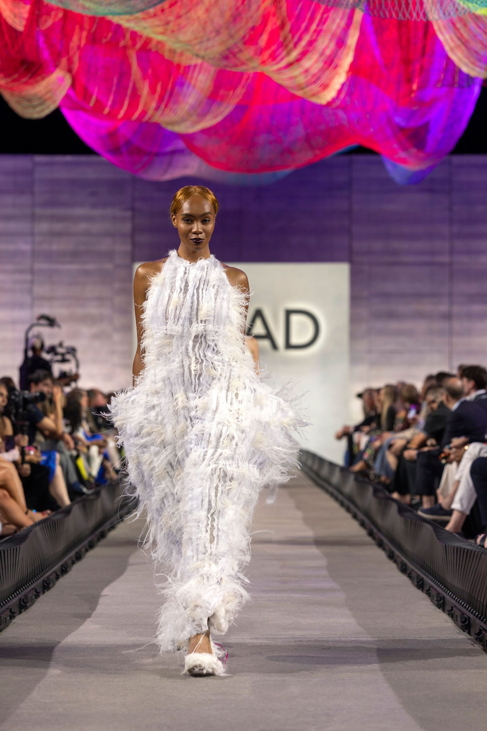 white feather sleeveless high-neck fitted draped flowing gown