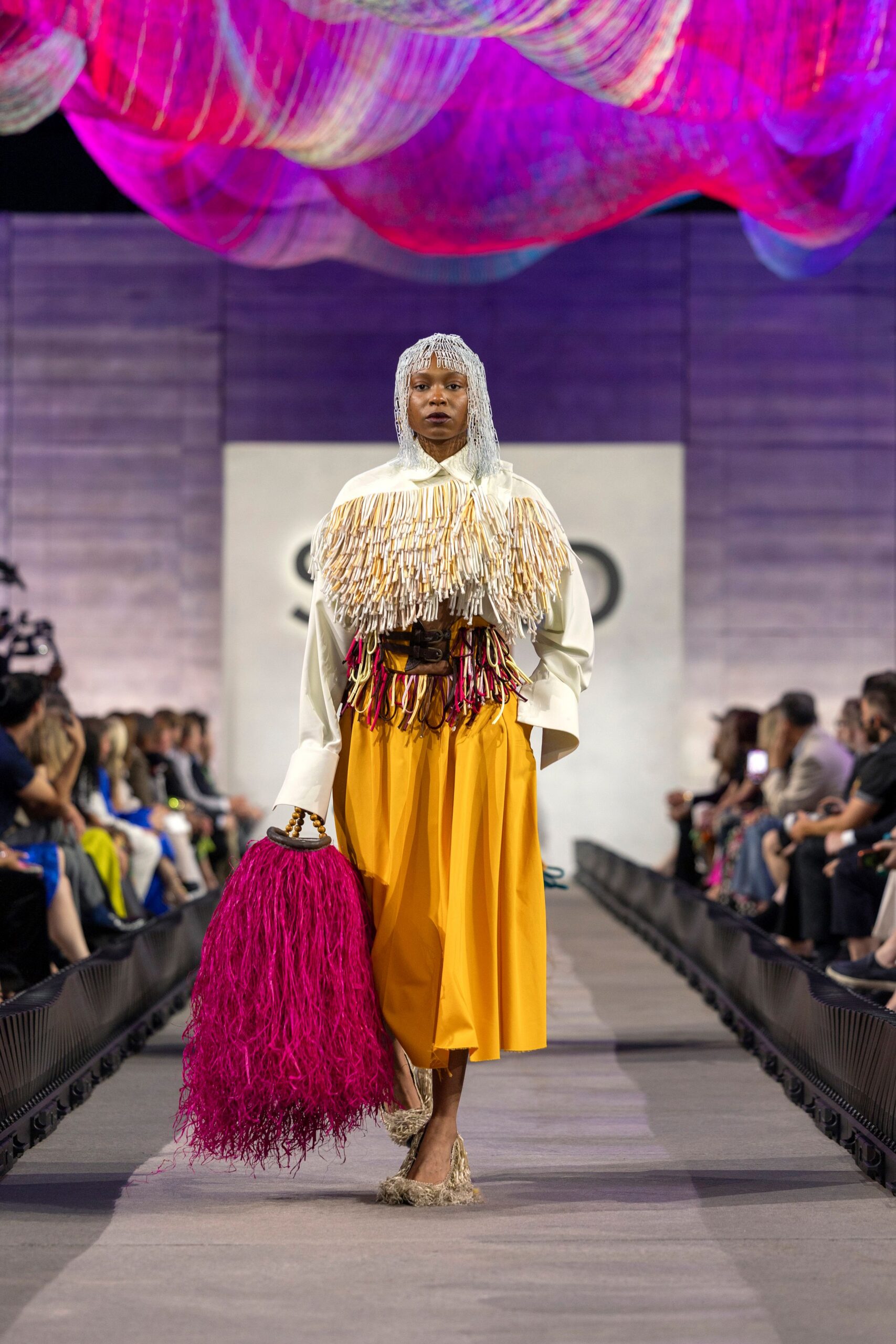 white fringed top and yellow skirt
