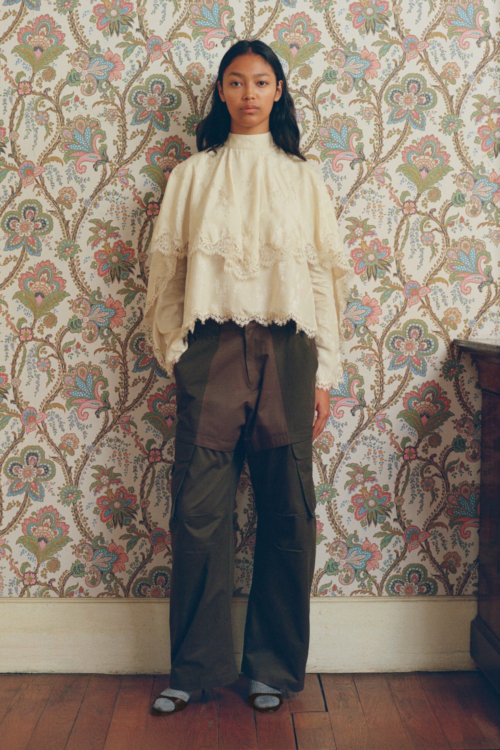 ivory ruffled top and green cargo pants