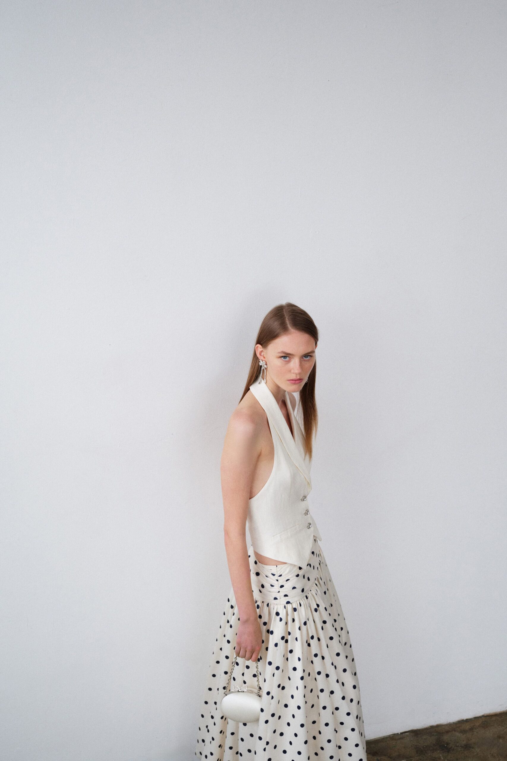 white fitted top with polka-dot skirt