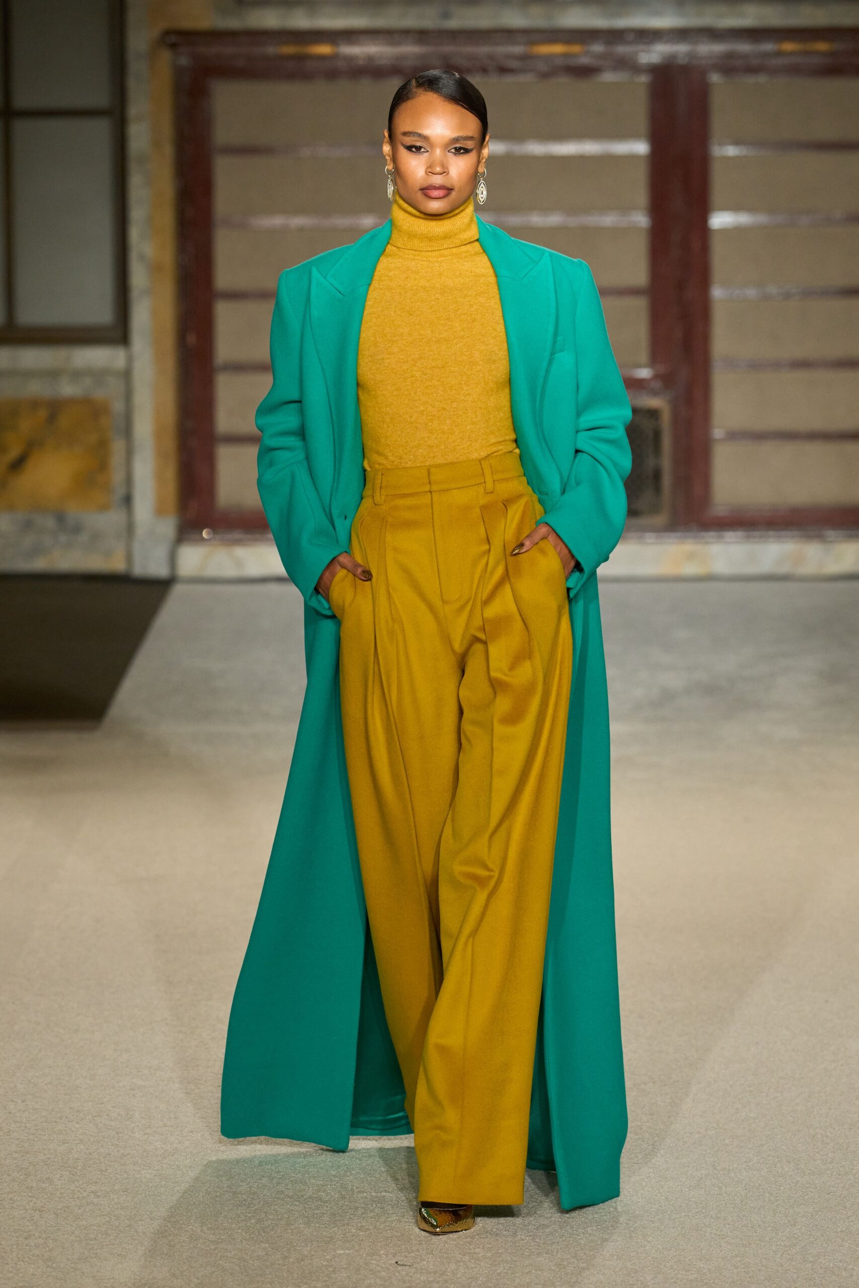 teal coat yellow top brown pants