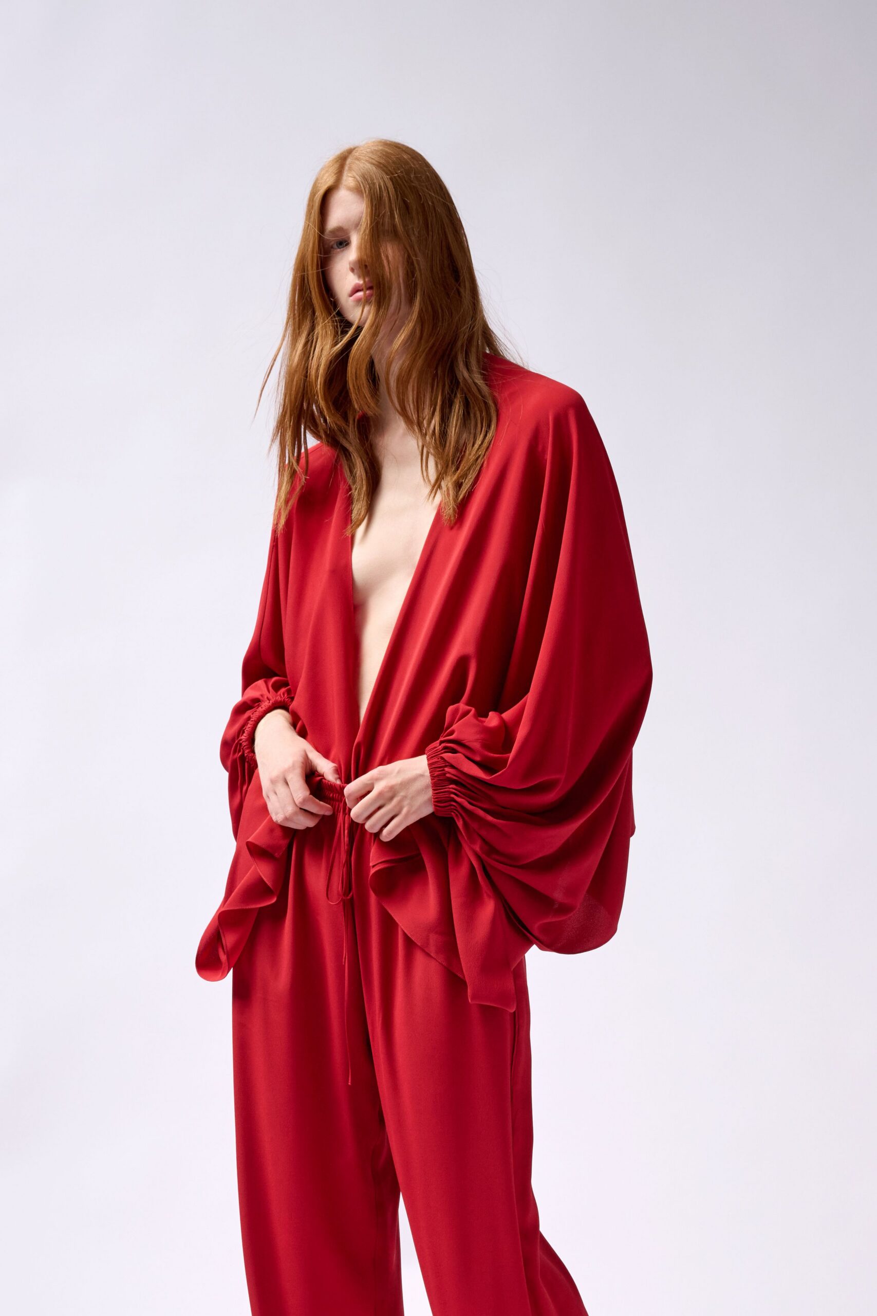 red silk long-sleeve v-neck relaxed draped top
