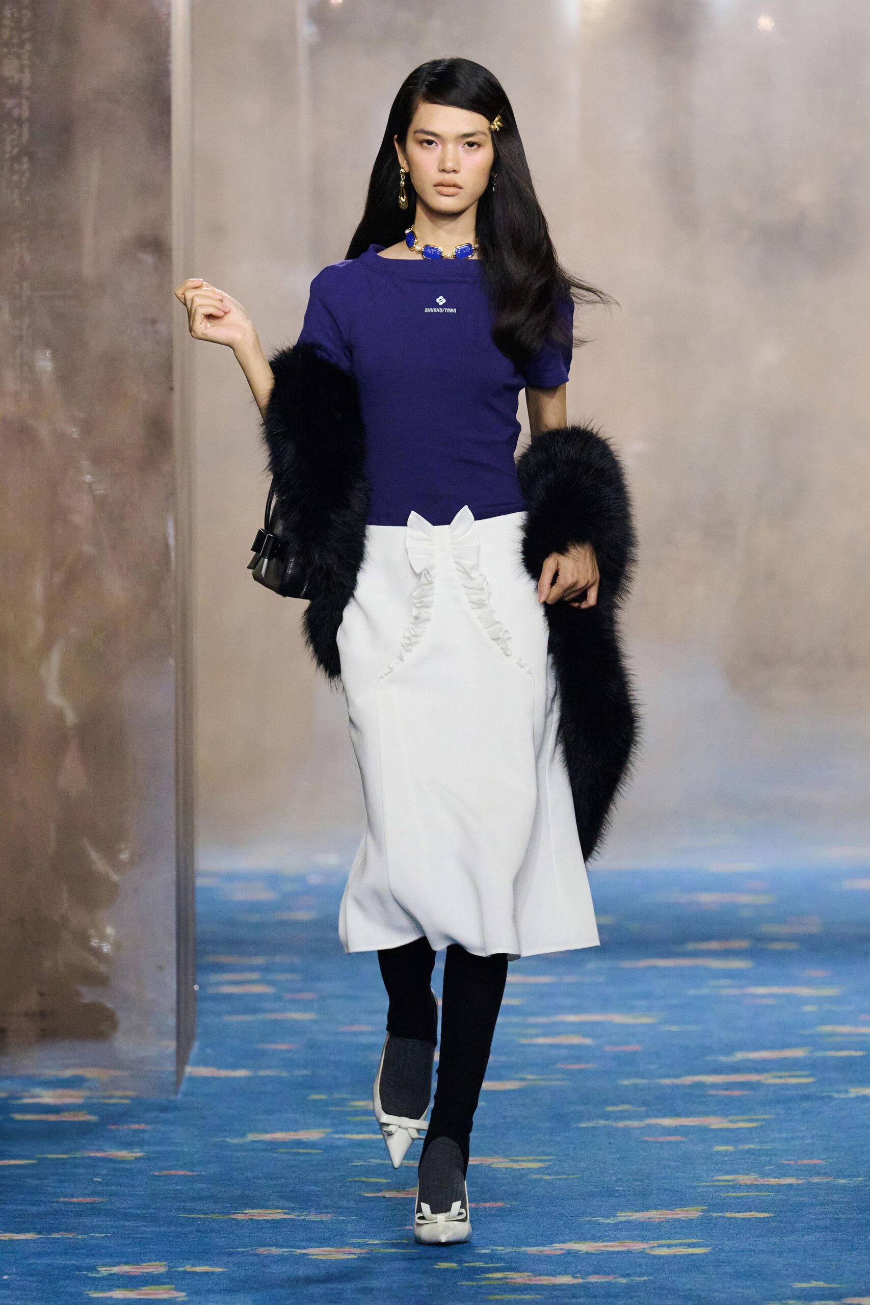 purple fitted top with white pleated skirt