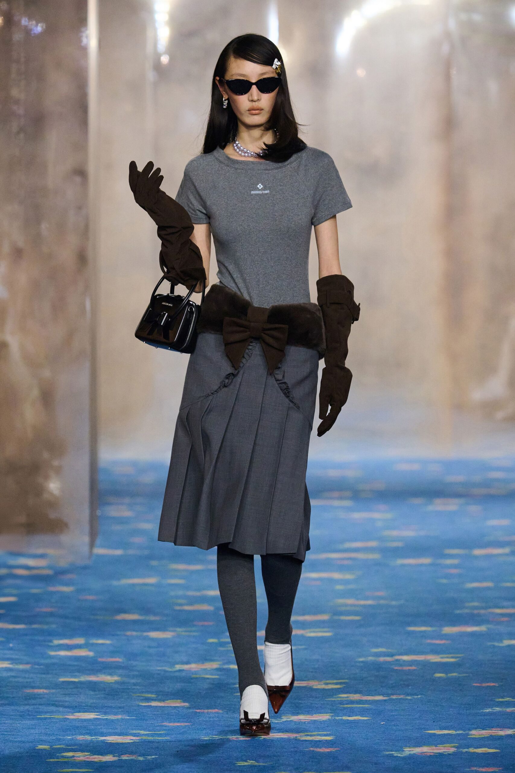 gray t-shirt and pleated skirt