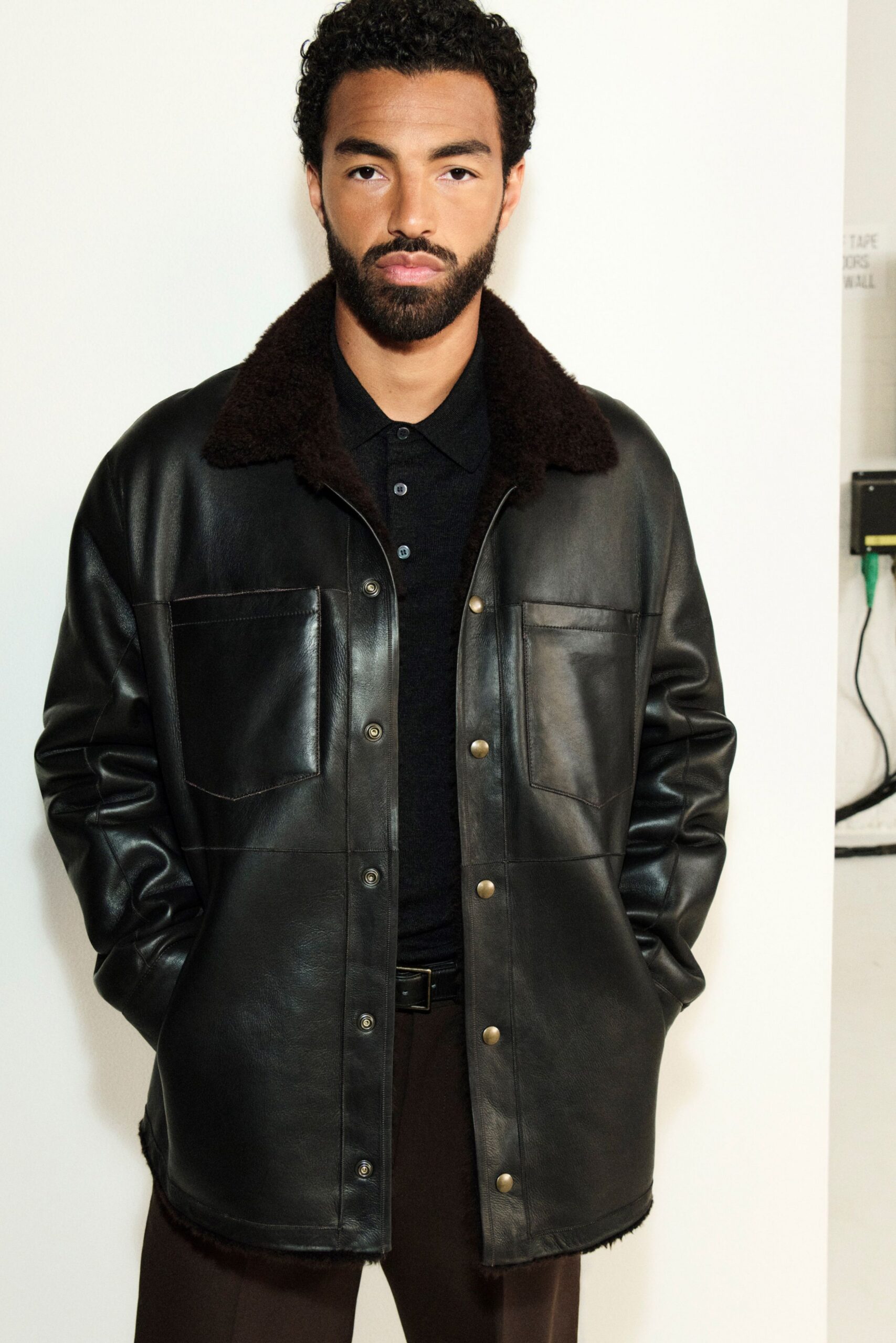 black leather long-sleeve collared relaxed buttoned jacket