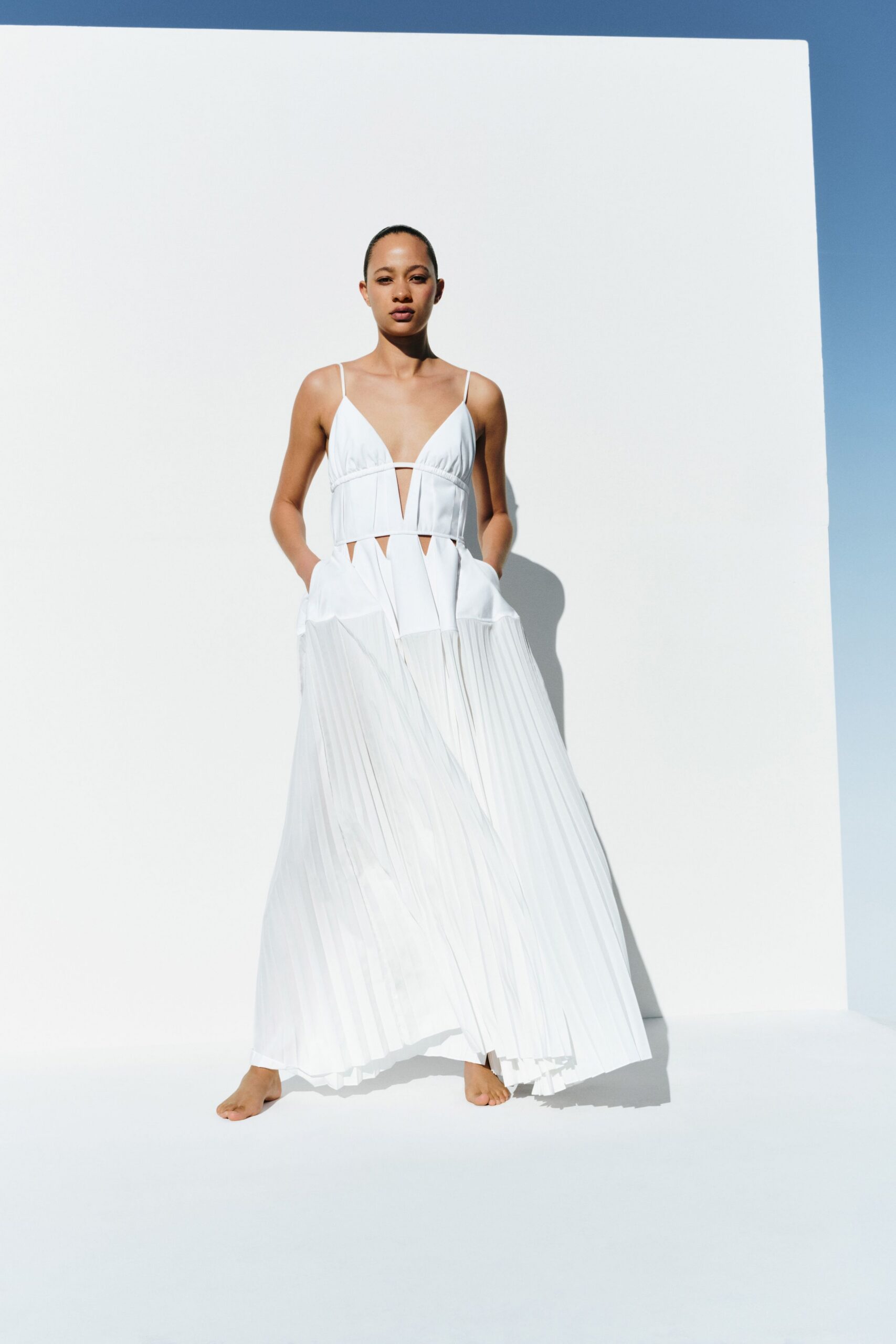 white pleated sleeveless gown