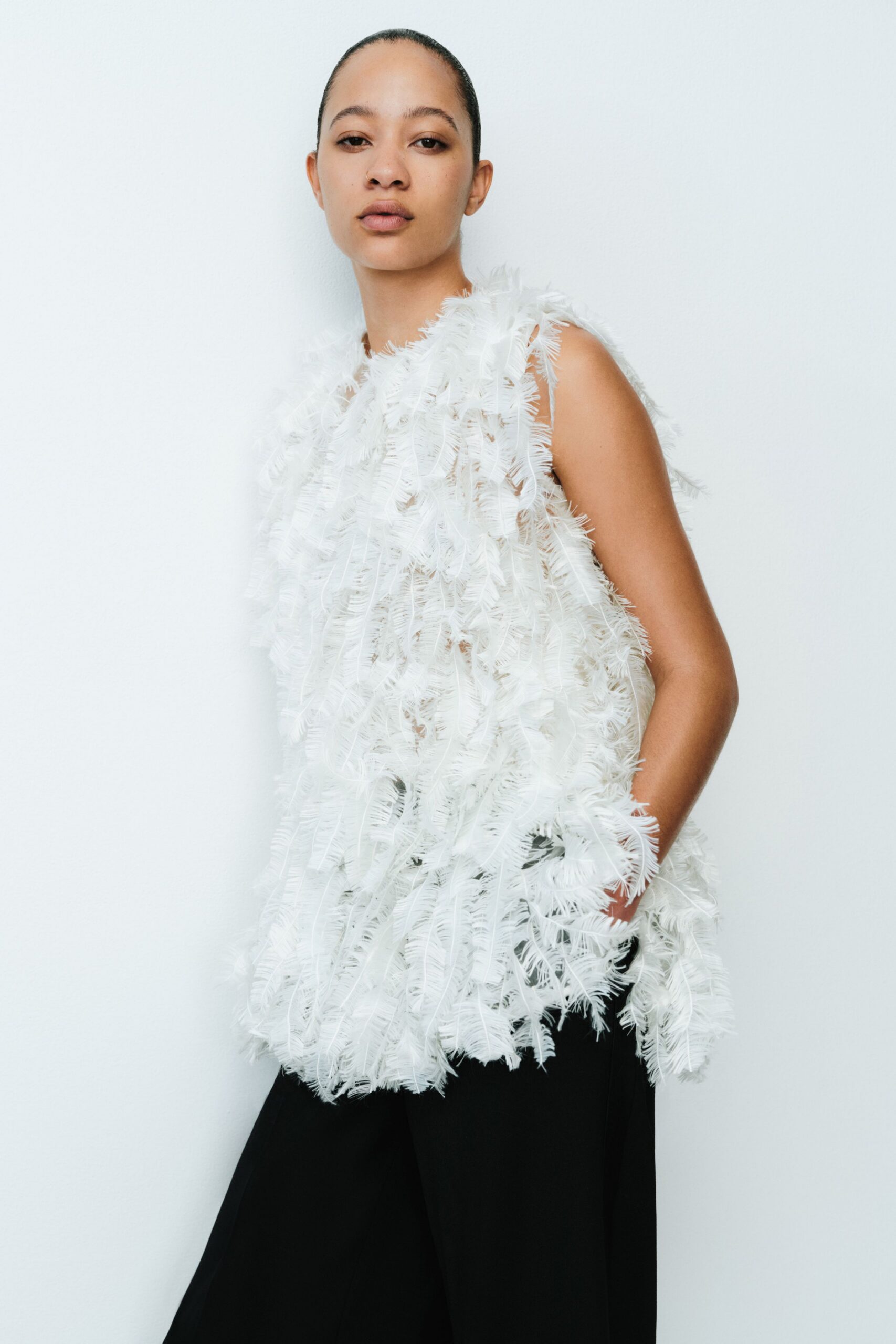 white fringed top and black pants