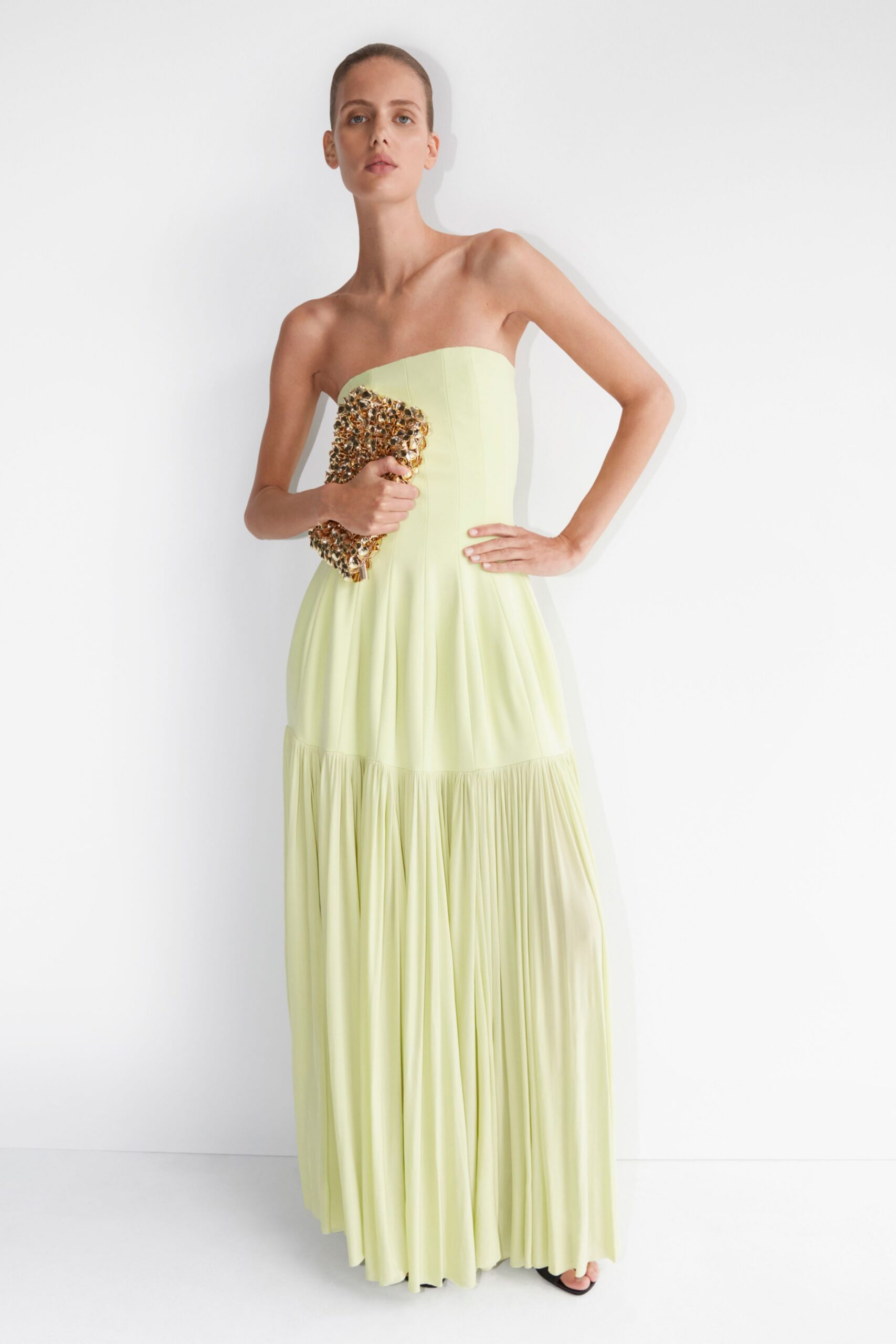 yellow silk strapless fitted pleated tiered flowing gown