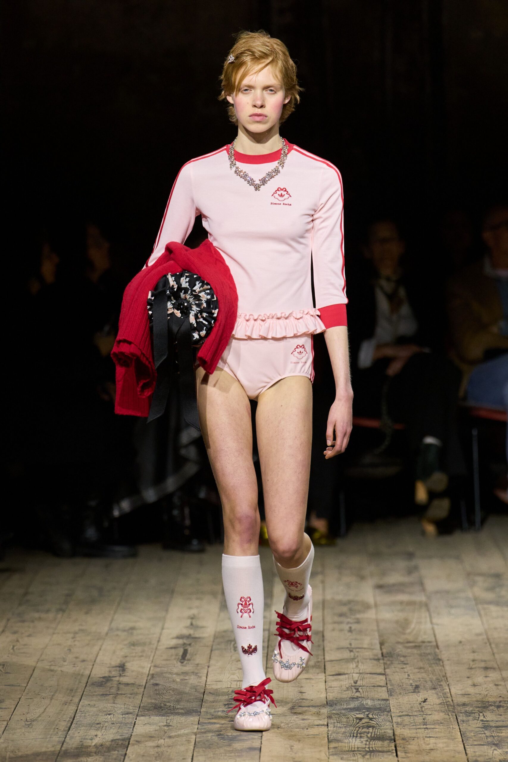 pink fitted top with red sweater