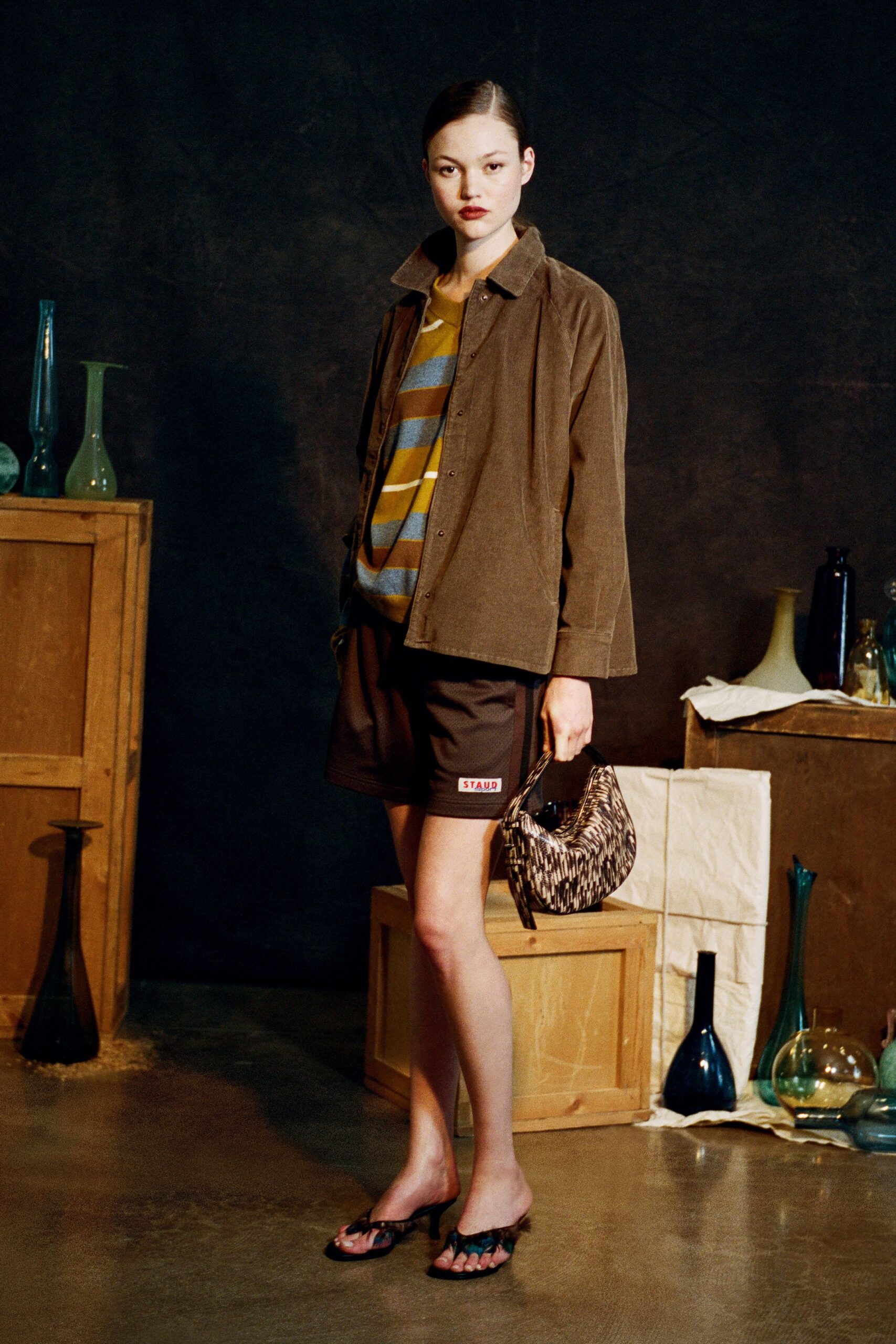 brown jacket gray striped top black shorts