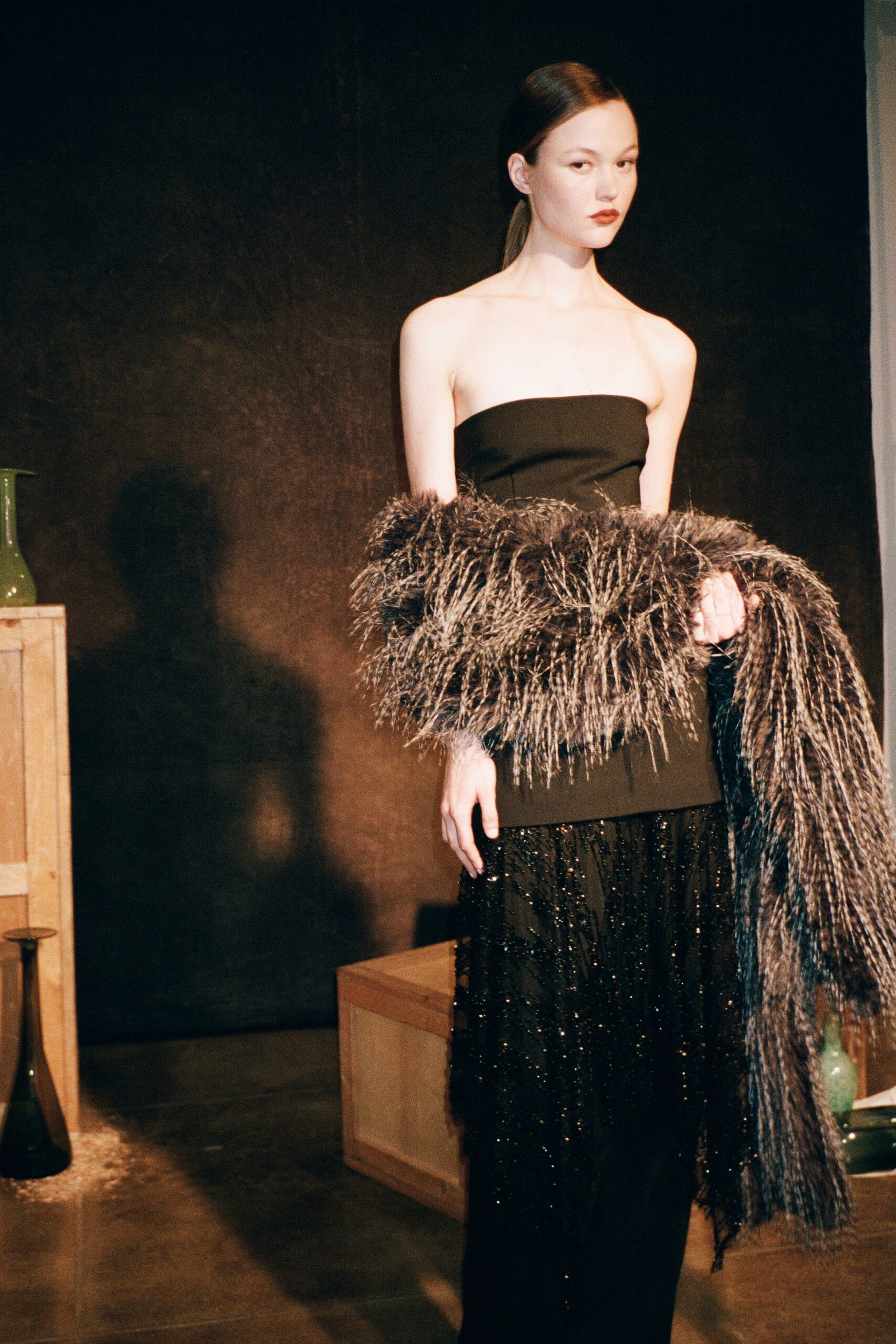 black silk strapless gown with gray fur cape
