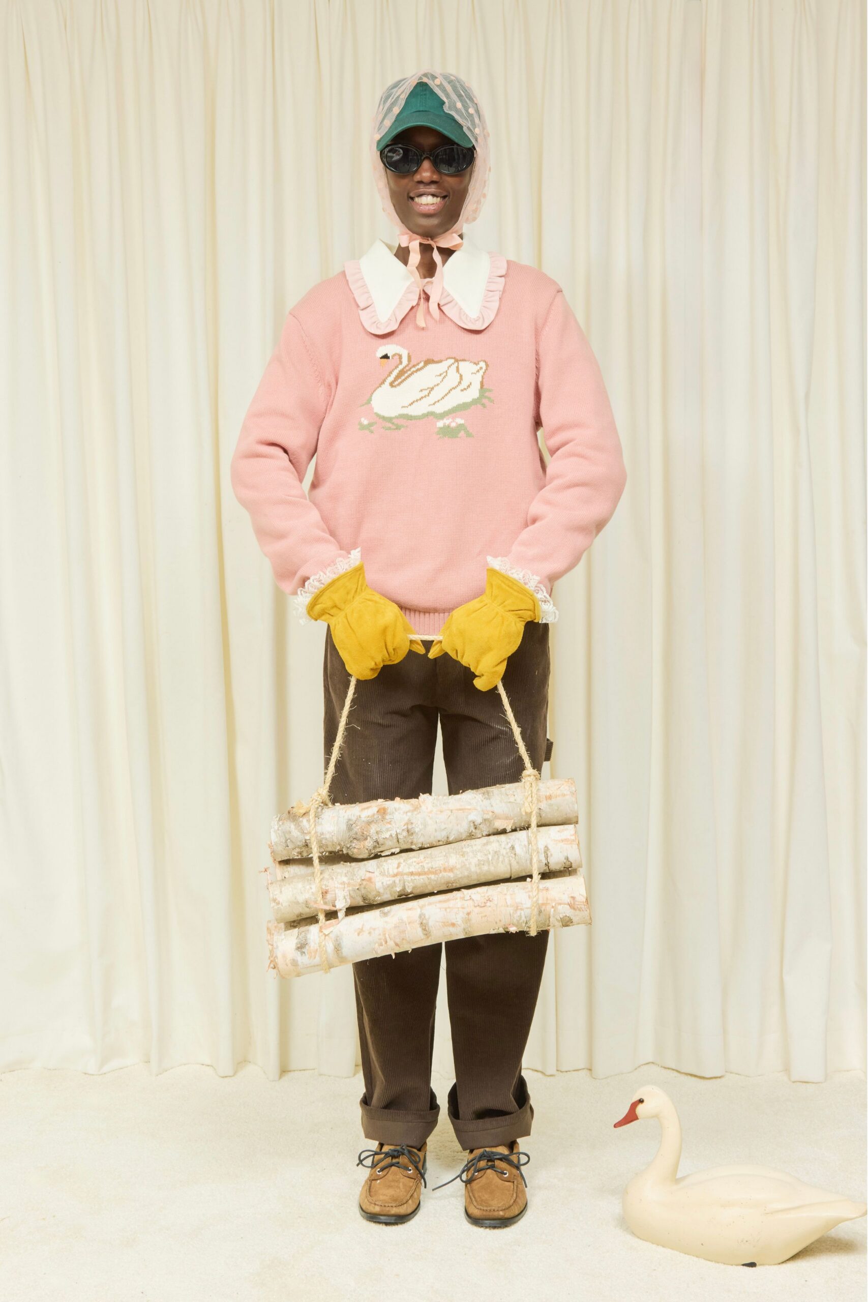 pink embroidered sweater with brown pants