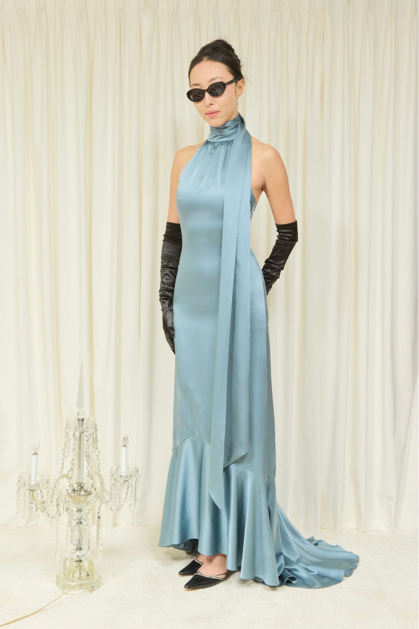 blue silk sleeveless high-neck fitted draped flared gown