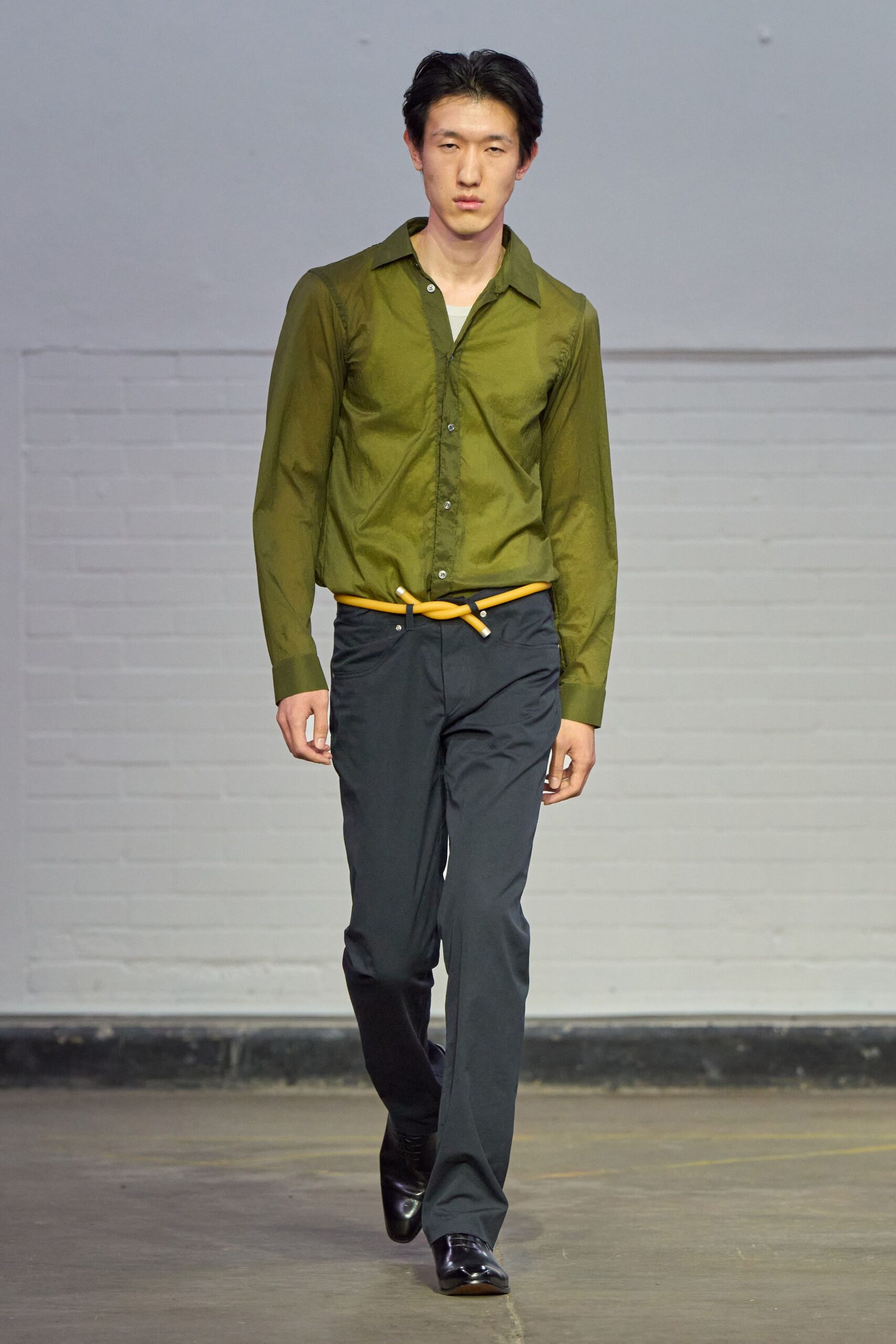 green fitted shirt black pants
