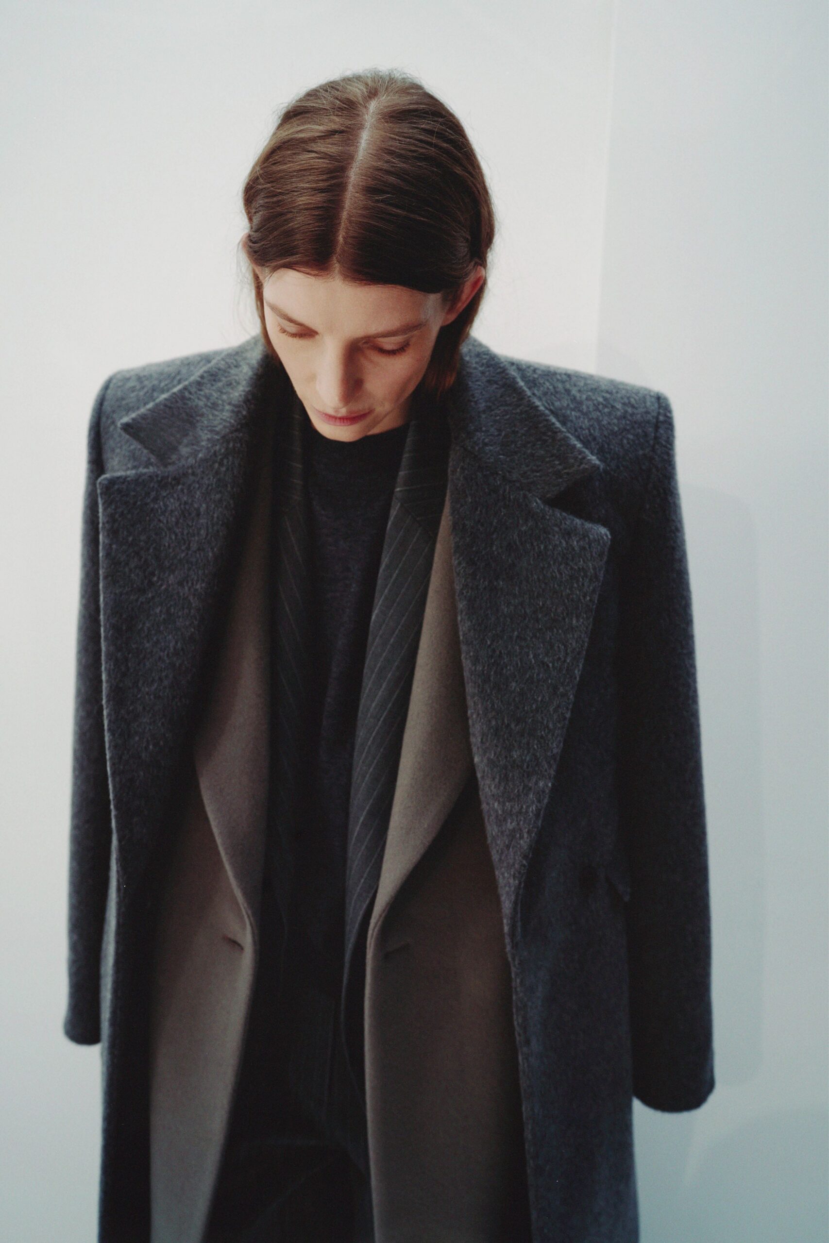 gray wool coat with black sweater and beige blazer