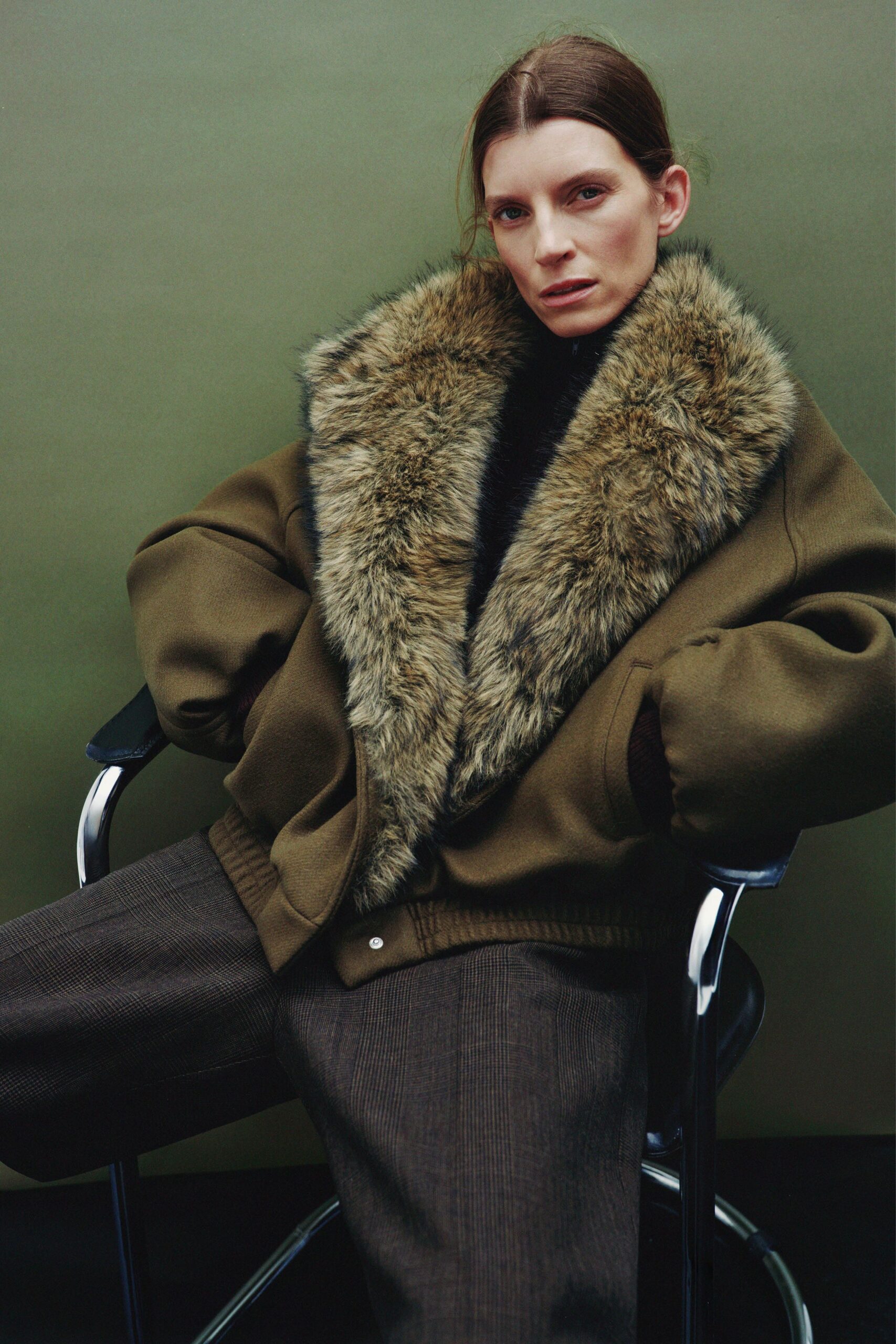 olive jacket black top brown pants