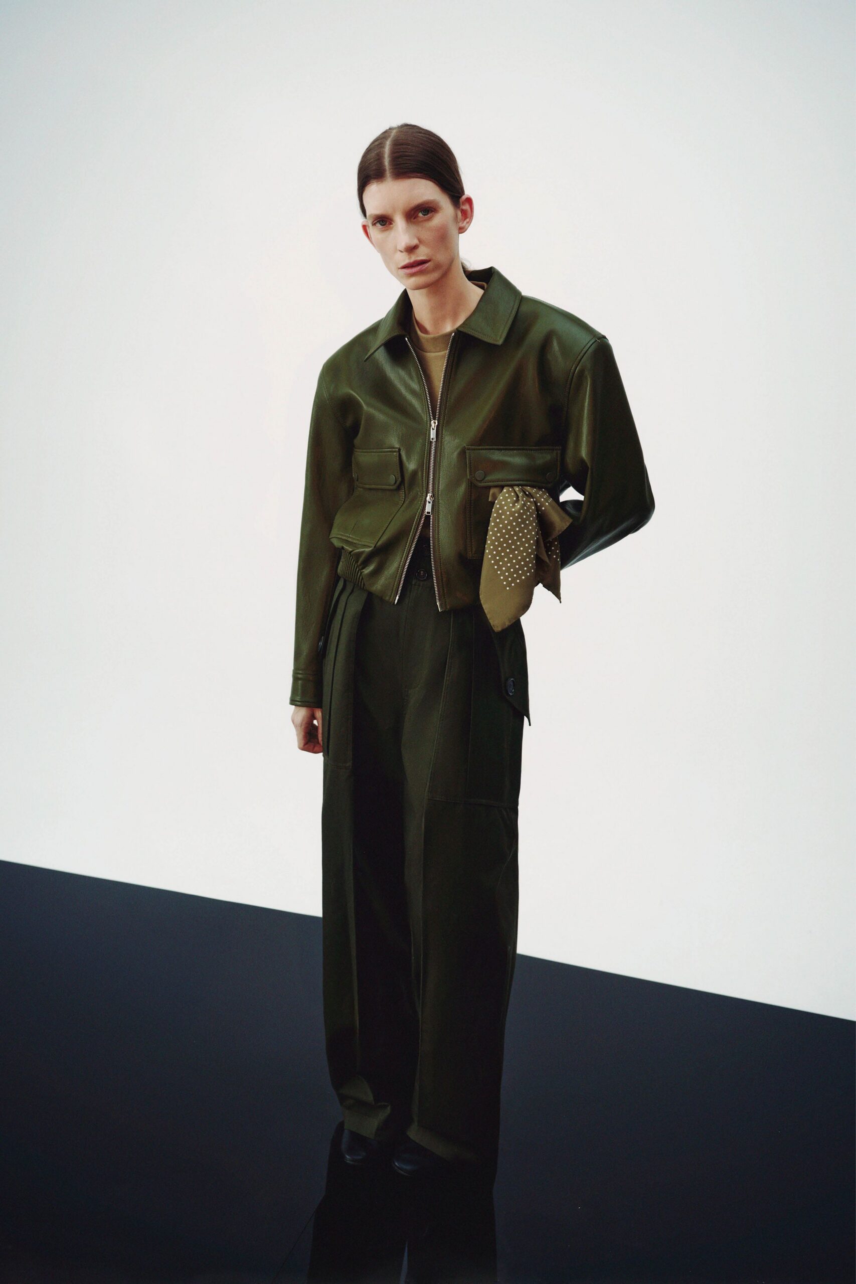 green leather long-sleeve collared fitted zippered pockets jacket