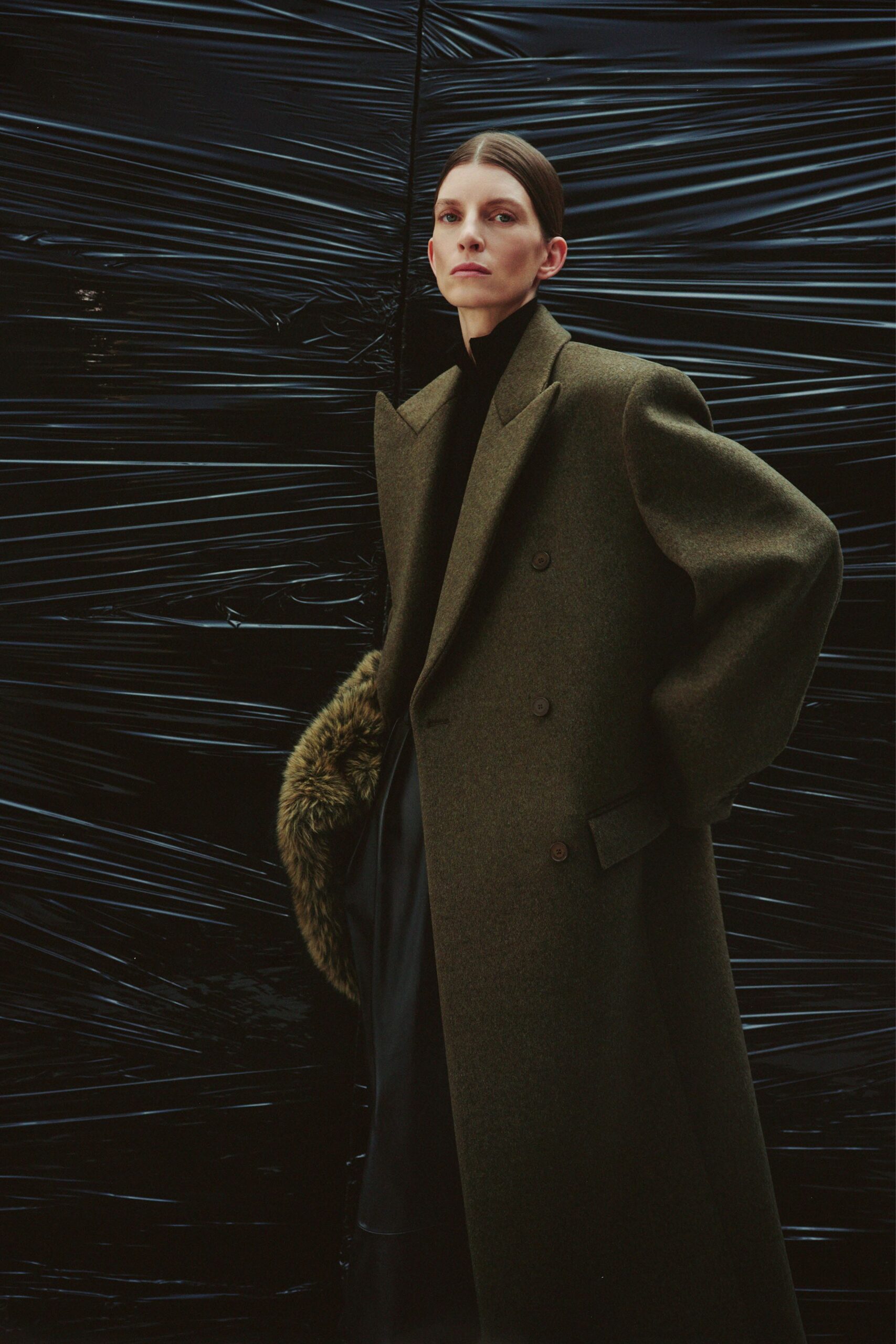 green wool tailored coat and black dress