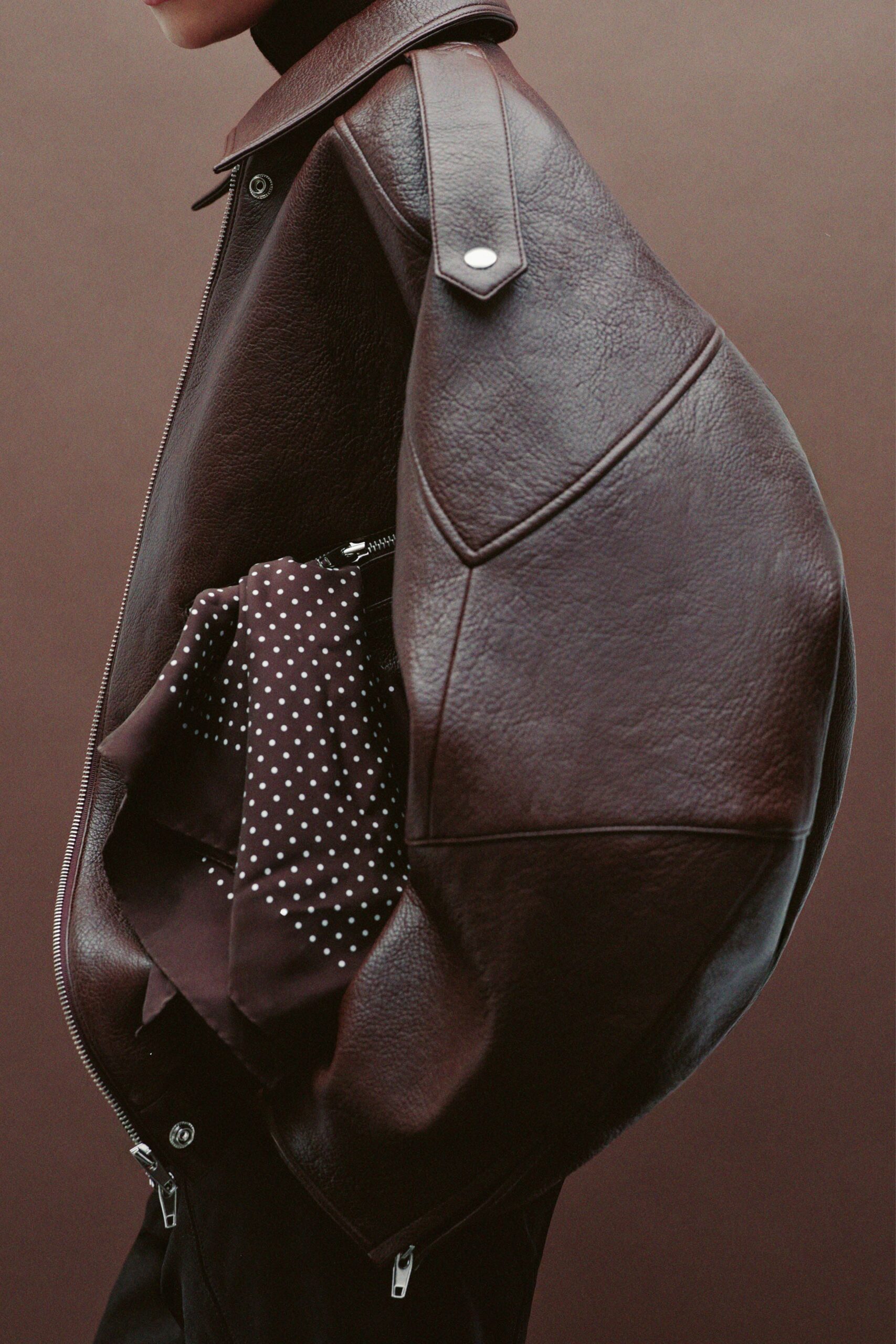 oversized brown leather jacket with polka-dot bag