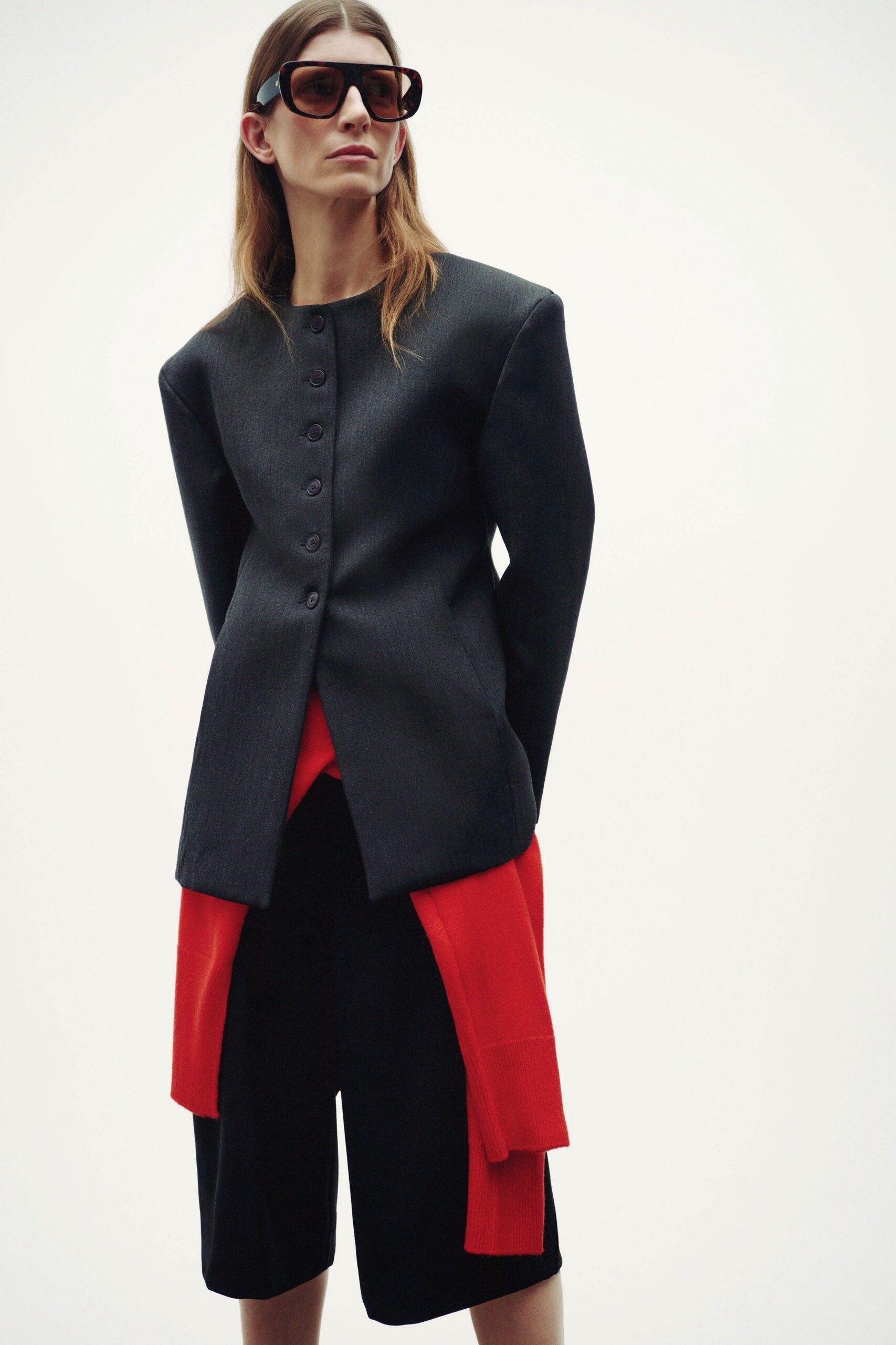 black blazer red top black shorts
