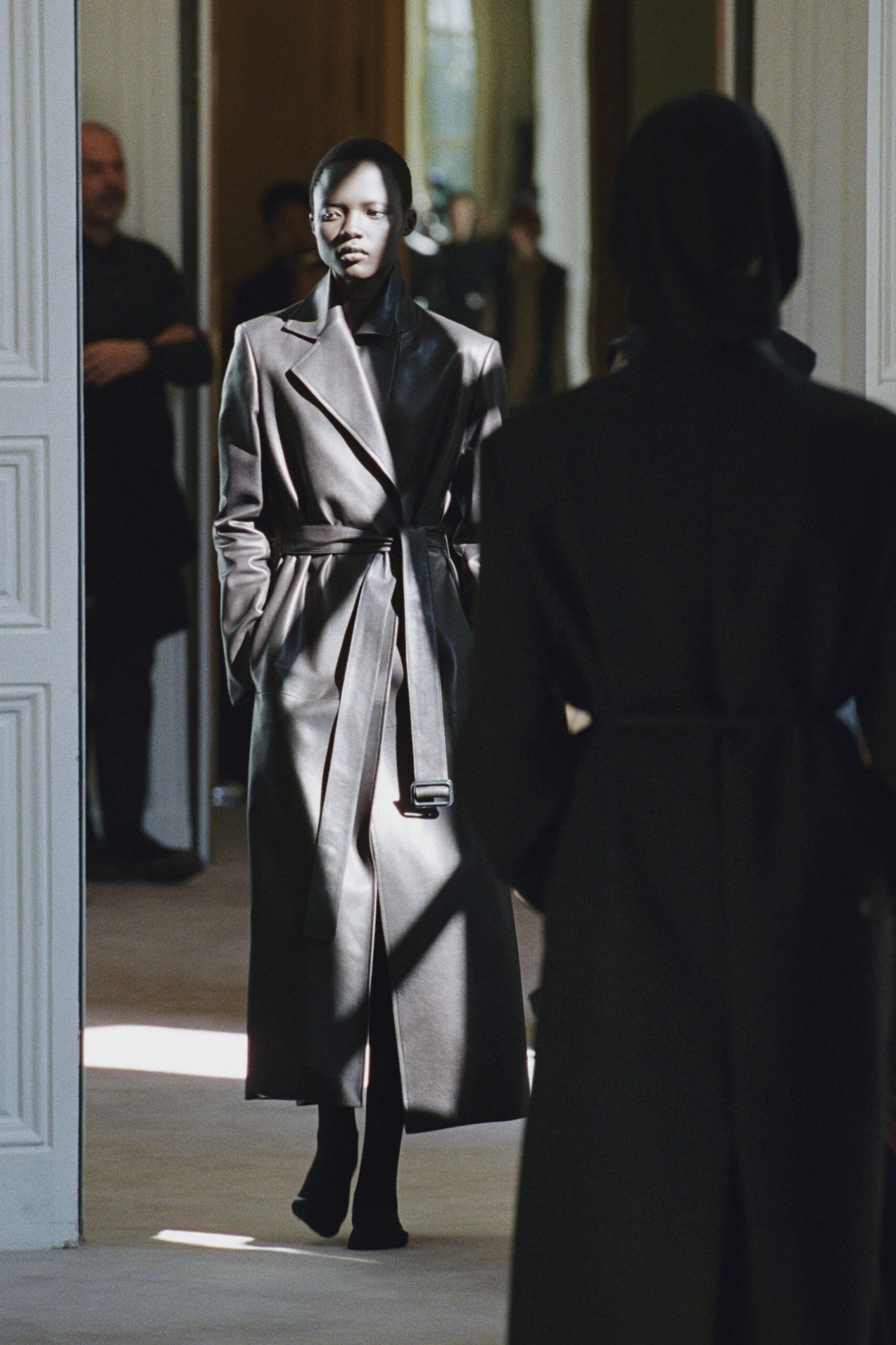 black leather long-sleeve collared fitted belted shiny coat