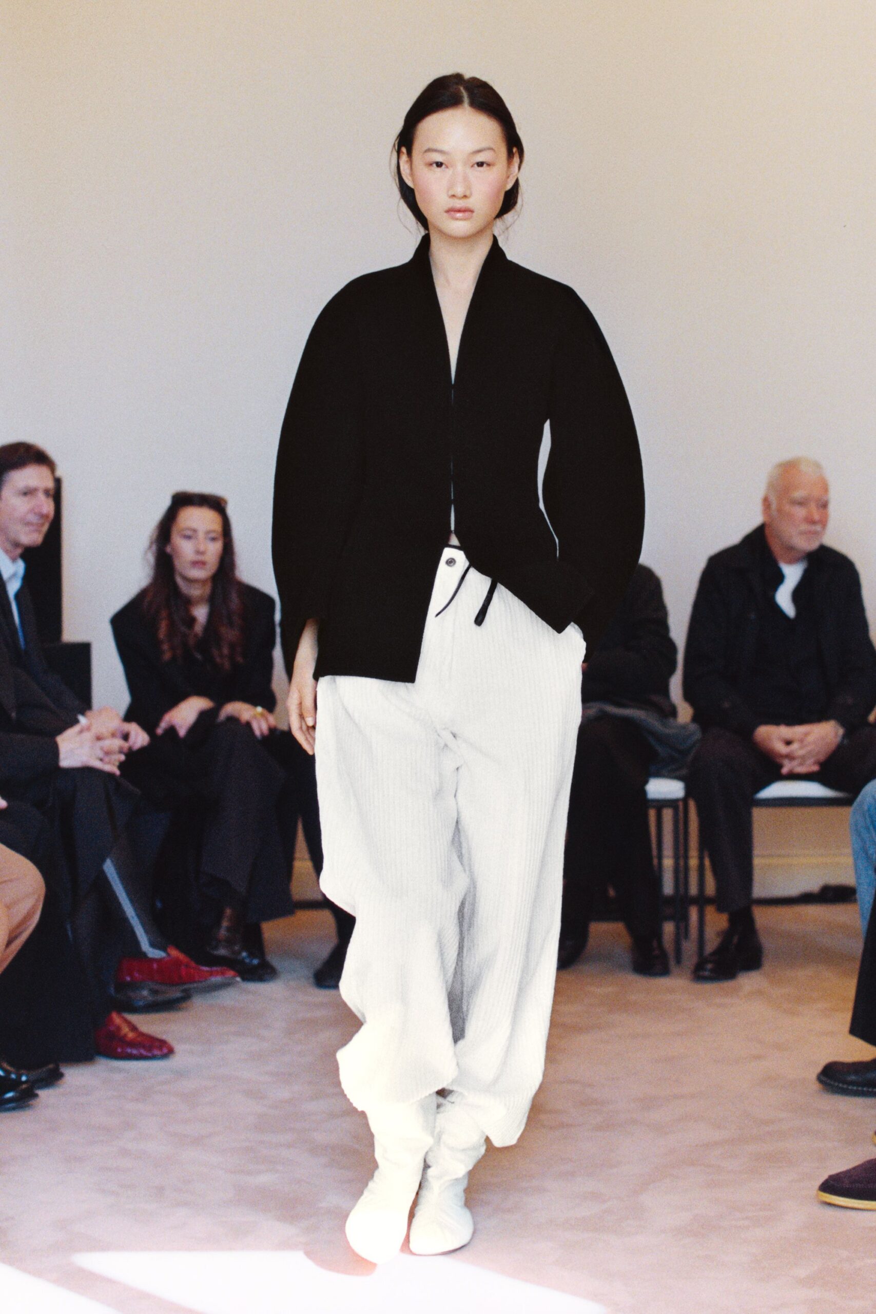black relaxed jacket white pleated pants