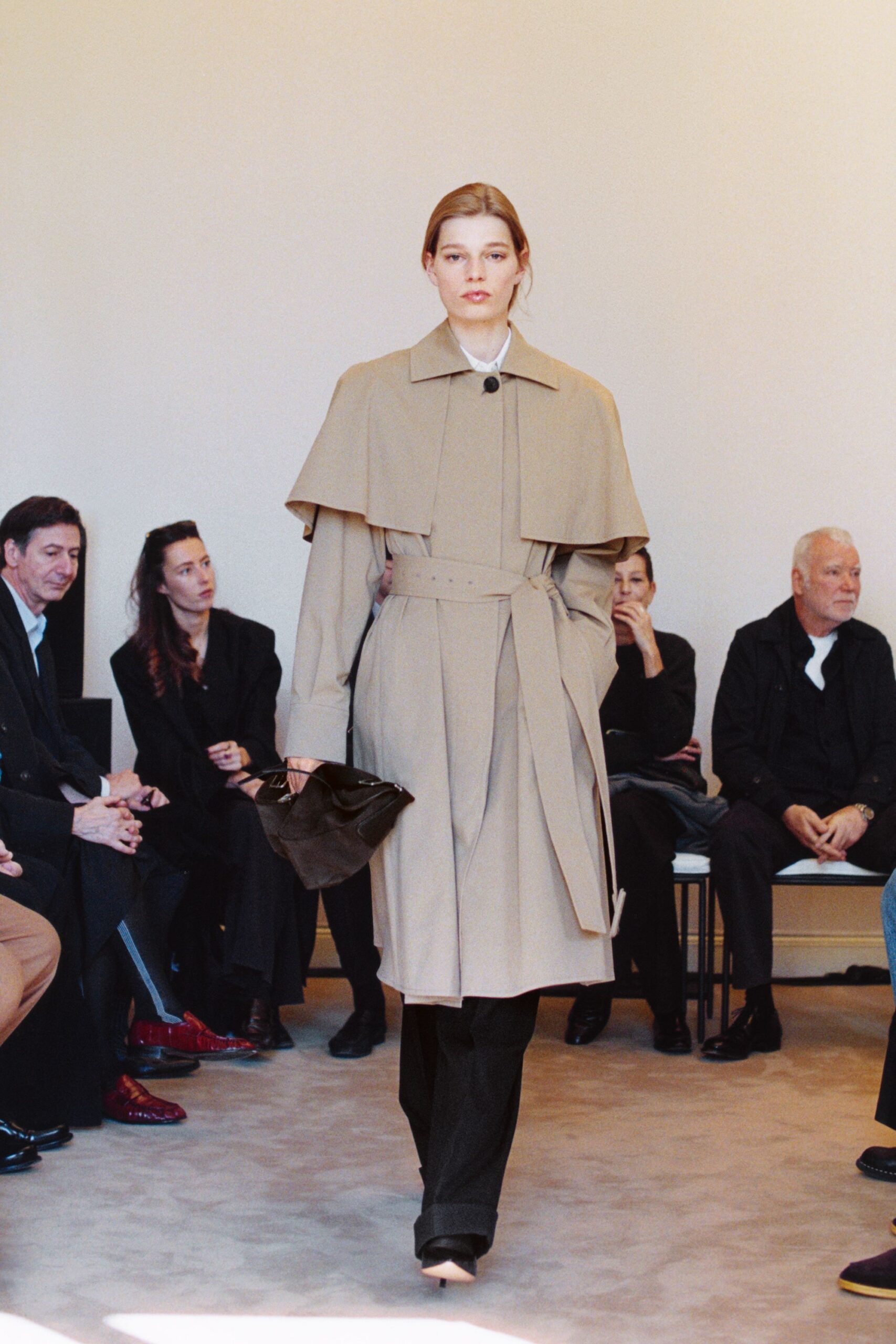 beige trench coat with black pants