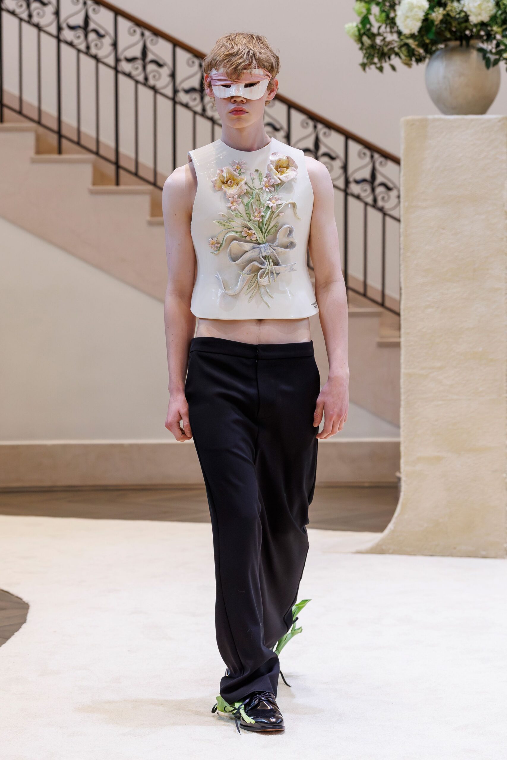 white embroidered sleeveless top with black pants