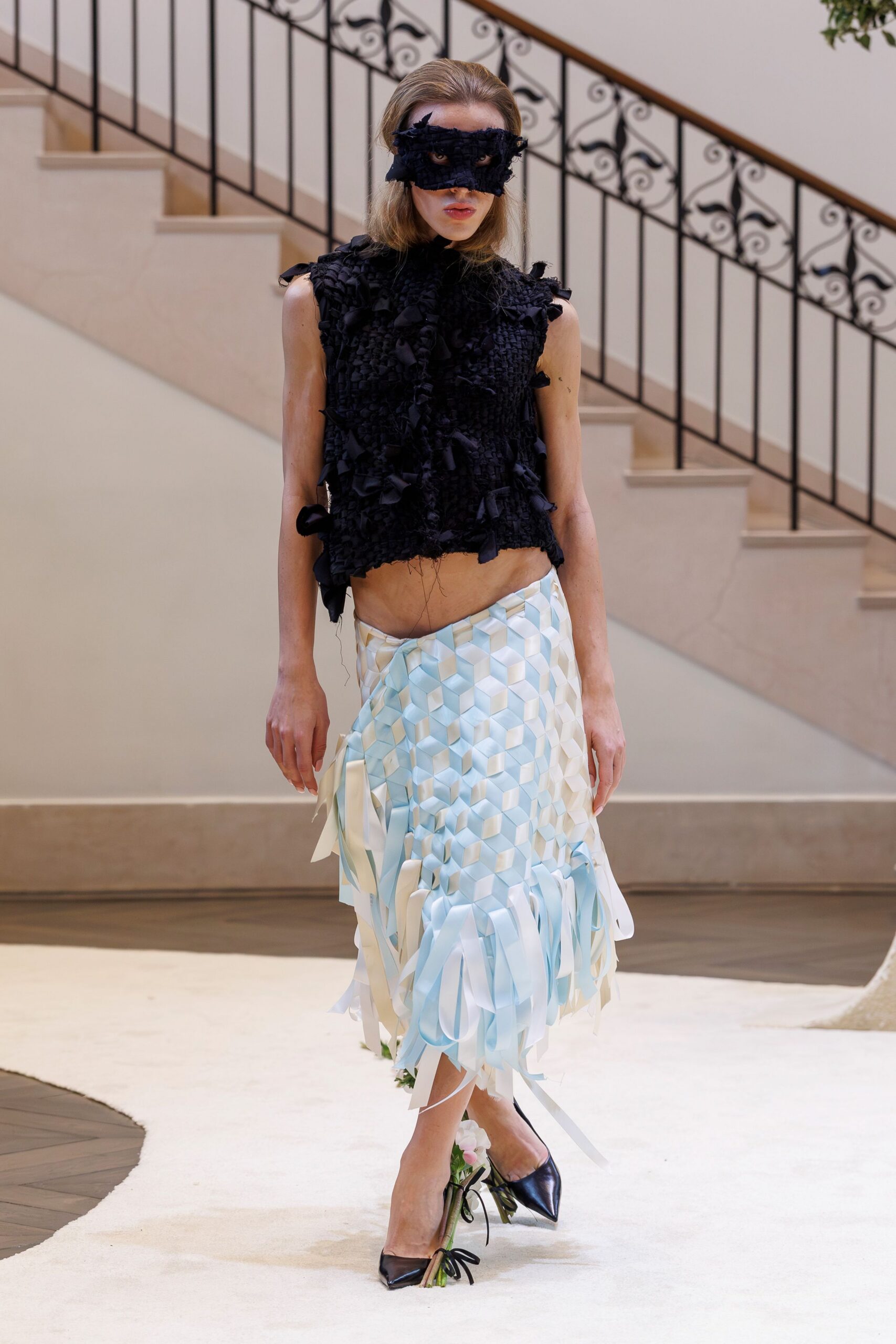 black ruffled top blue pleated skirt
