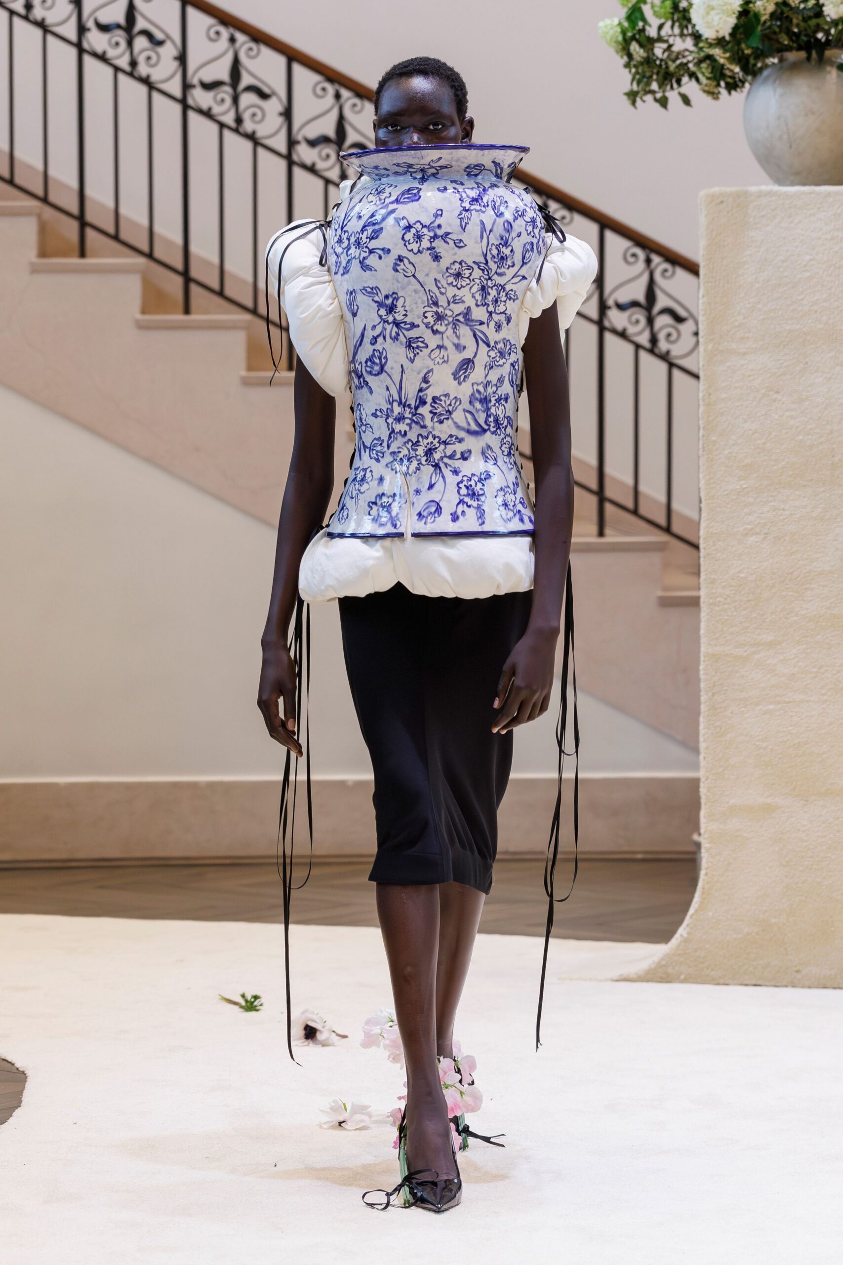 white blue embroidered top with black pants
