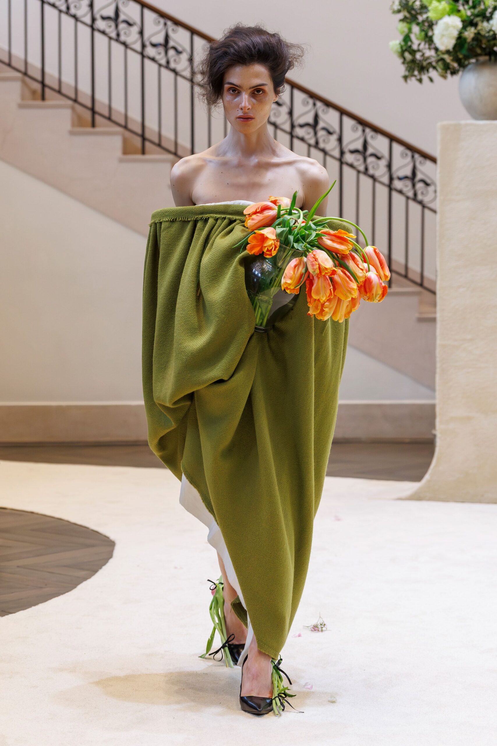 green draped strapless dress with black shoes