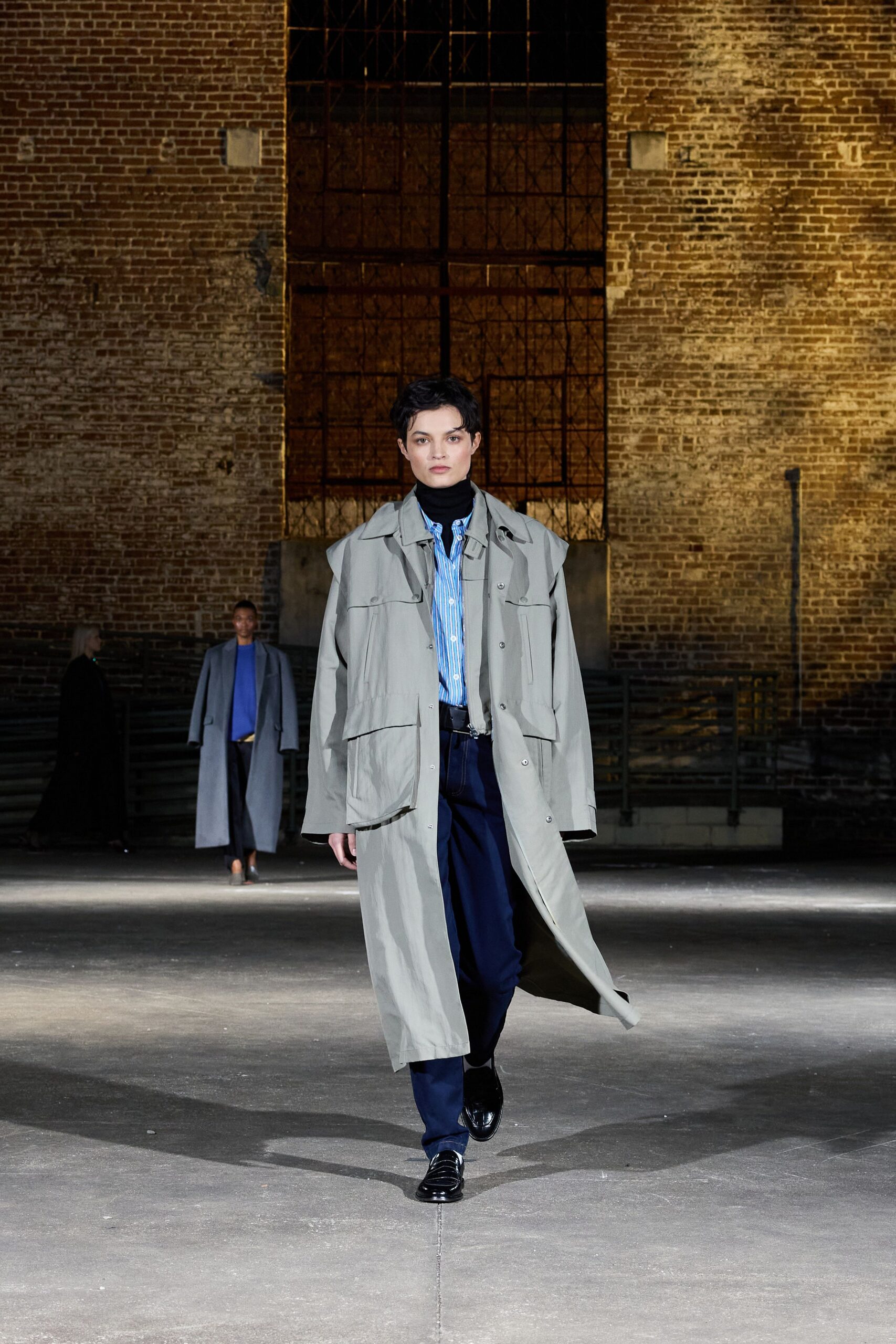 gray coat blue shirt black pants