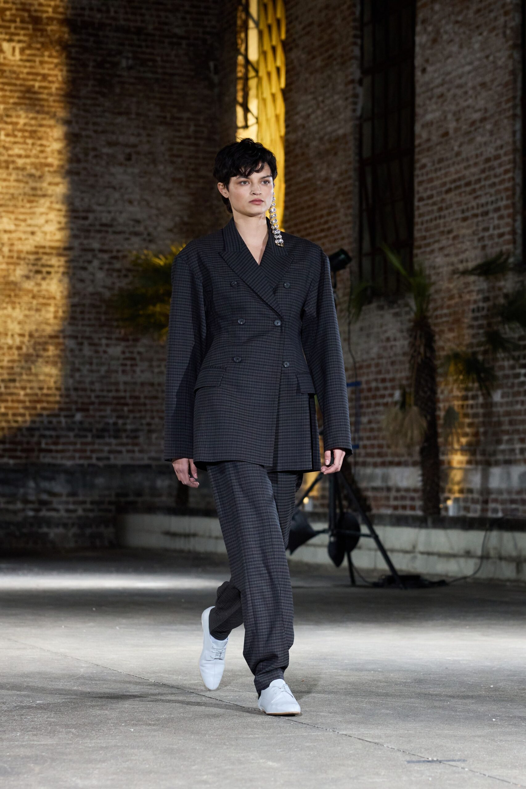 black and gray tailored suit with white shoes